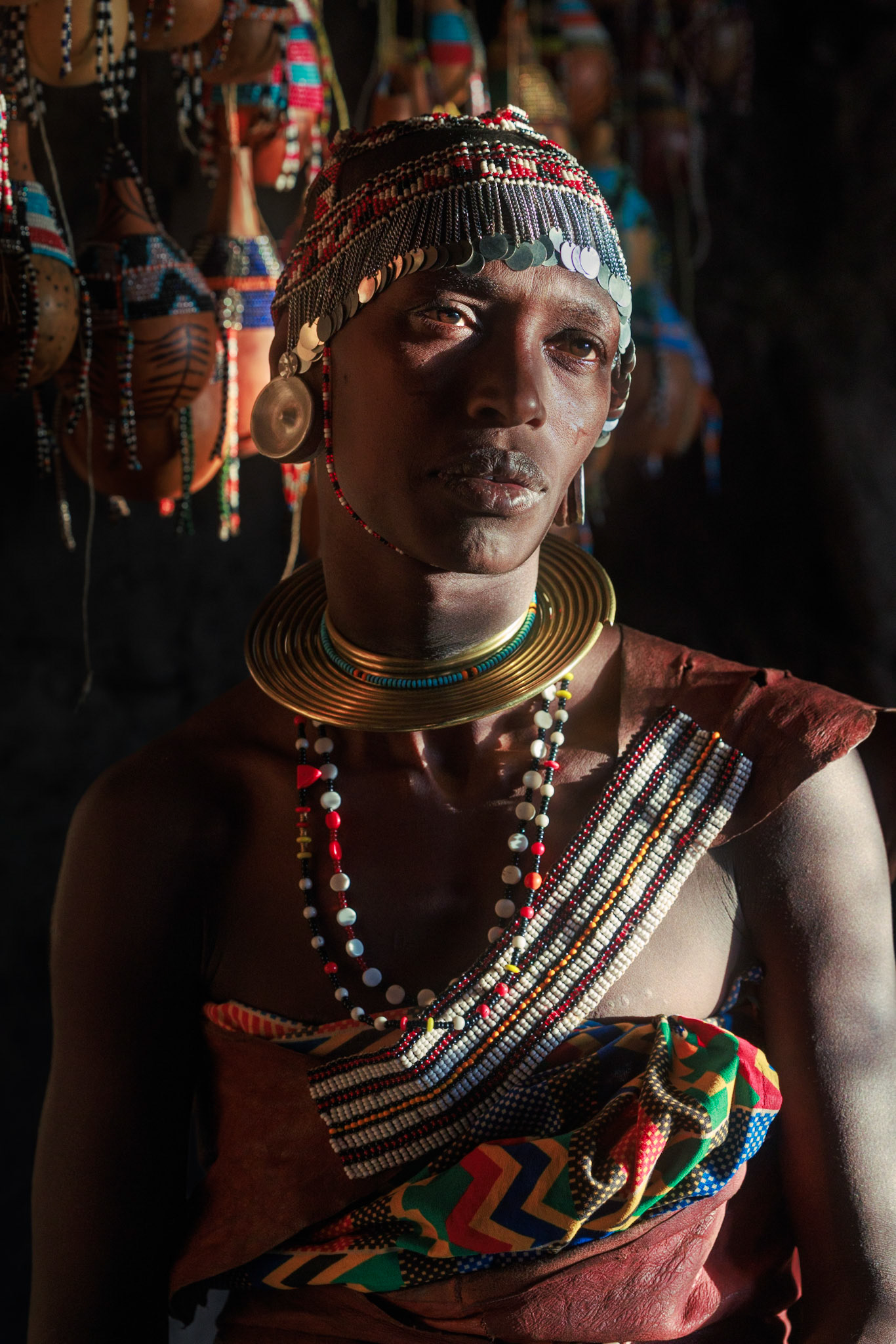 Adorned in History — Resplendent in intricate beadwork and brass coils, this subject embodies the pride of the Datoga people. Each strand of beads and piece of metalwork represents skilled craftsmanship passed down through generations, signifying her social standing and cultural heritage.