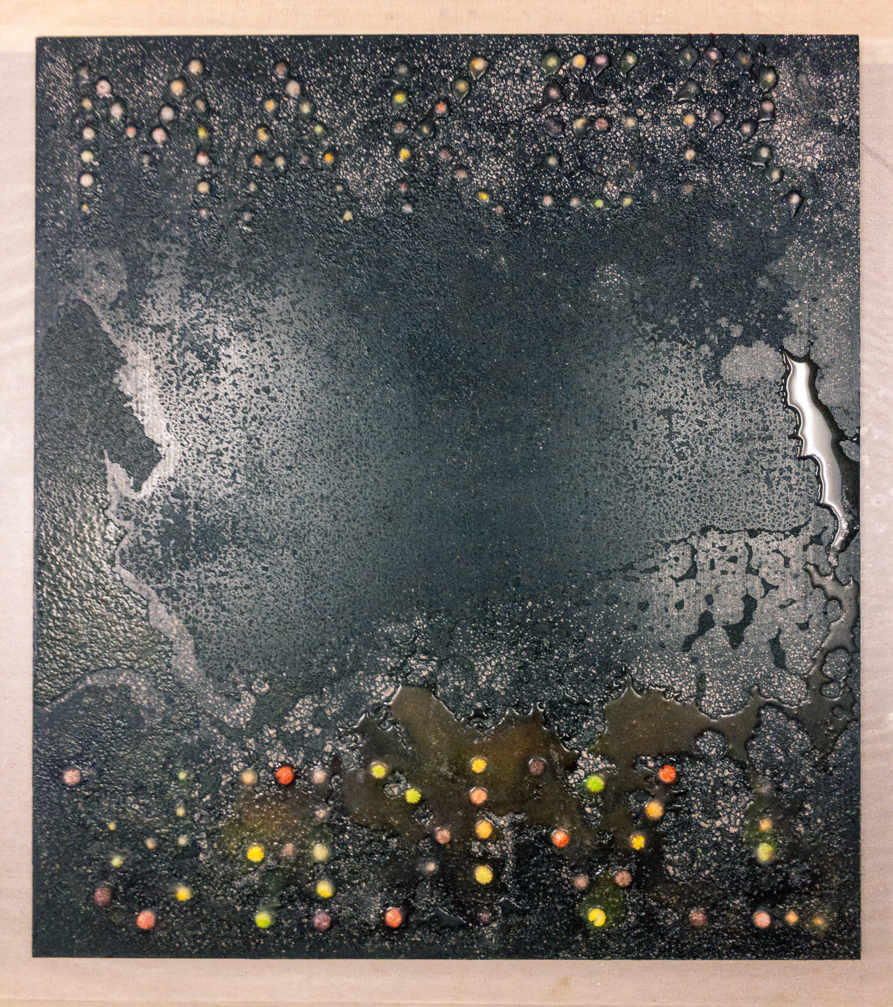 Makertaker I, 2019. Asphaltum and salt with skittles on panel.