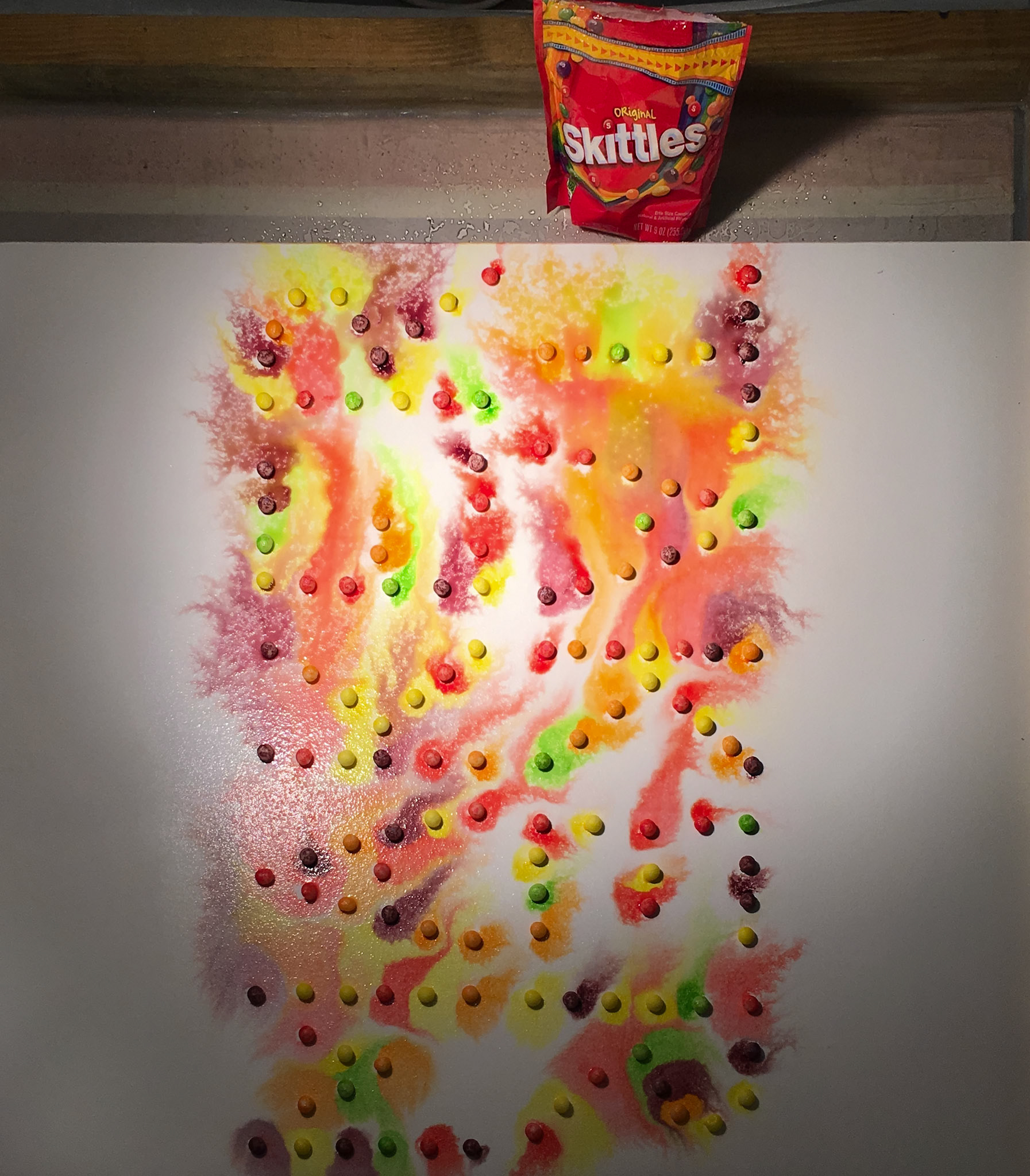 Makertaker II, 2019. Skittles-dyed paper on cotton rag paper mounted to wood panel.