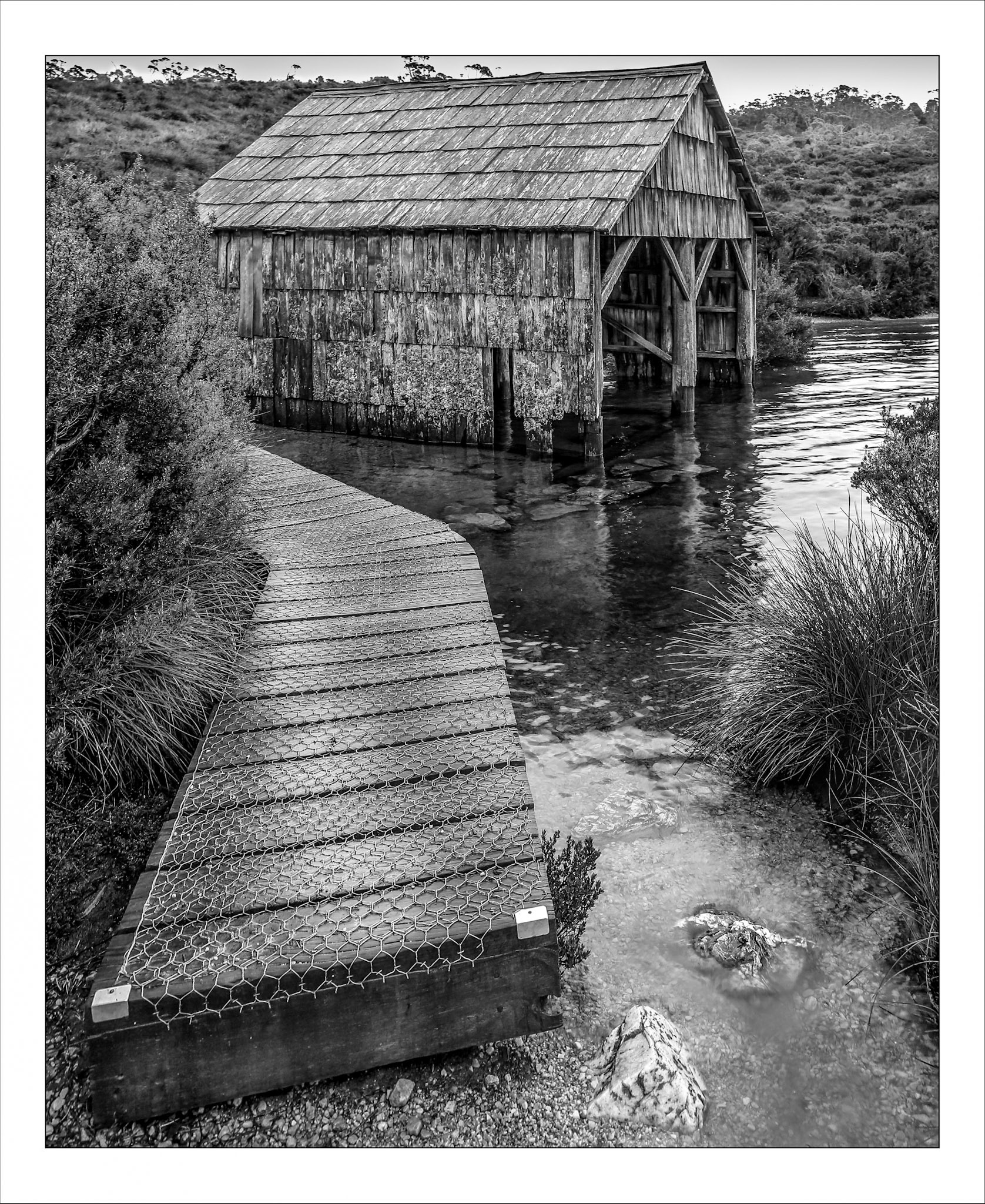 Boardwalkand boatshed on shore of Dove Lake