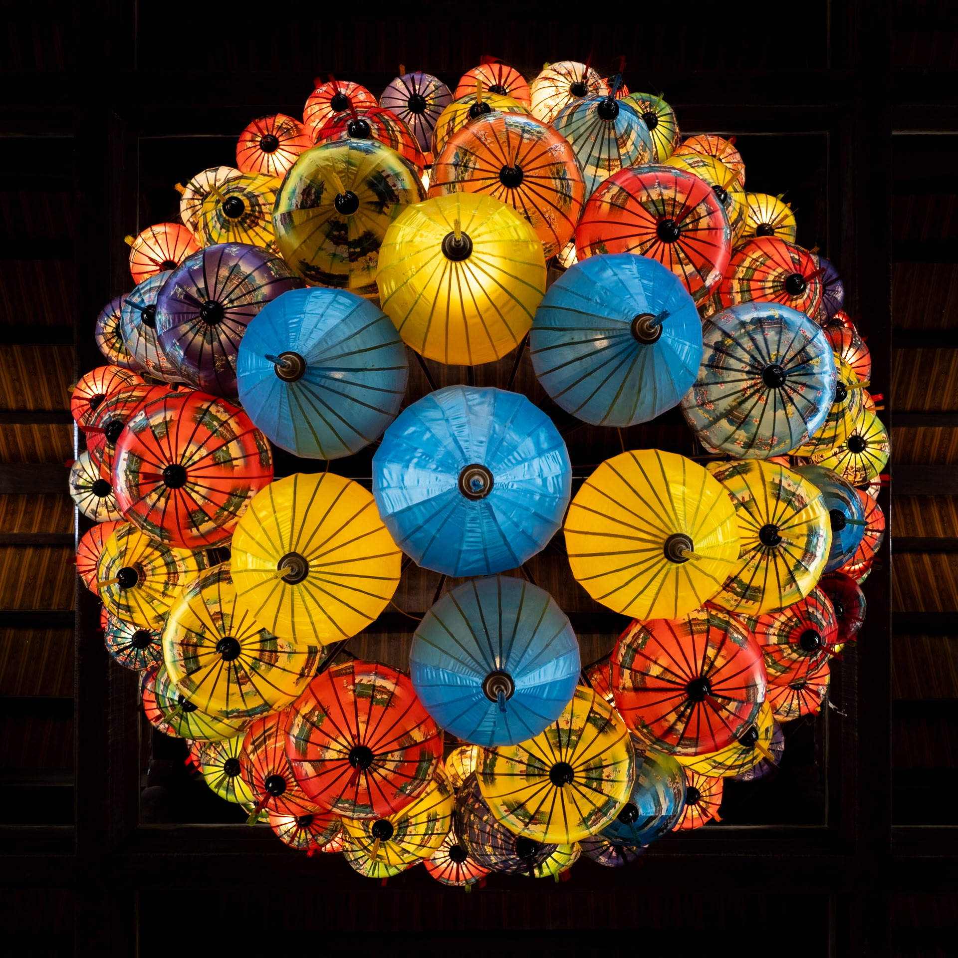 A magnificent collection of traditional lanterns hang high in the ceiling of a traditional building at Trang An in the Ninh Binh region of Vietnam
