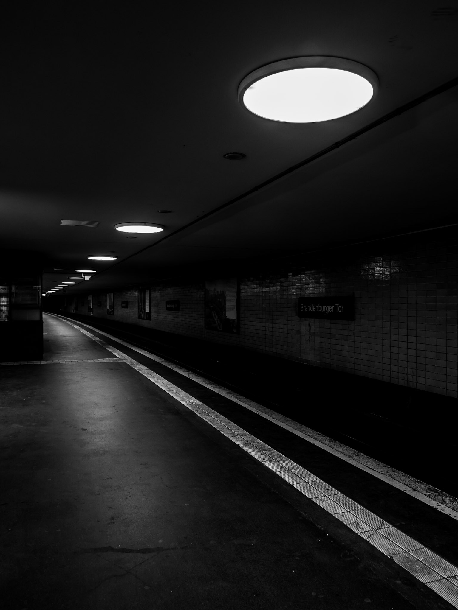 A S-Bahn station stands deserted late at night in the city of Berlin