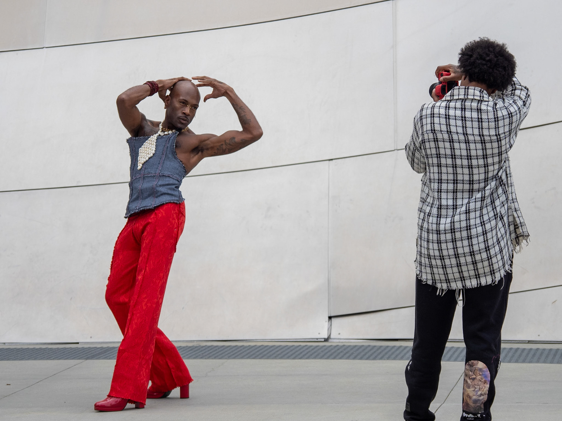 A model strikes a dramatic pose during a photoshoot on the streets of downtown Los Angeles