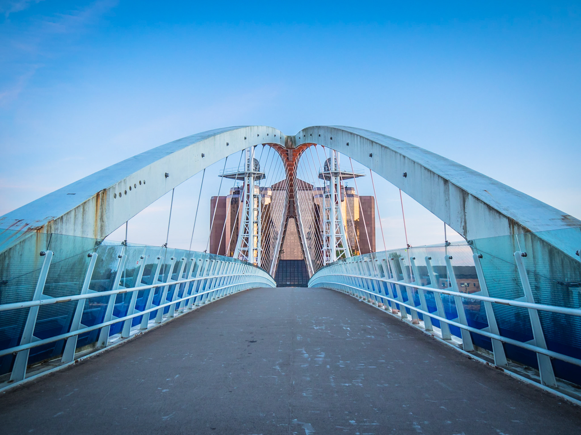 Rust starts to form on the structure of an arched bridge in Salford Quays, Manchester