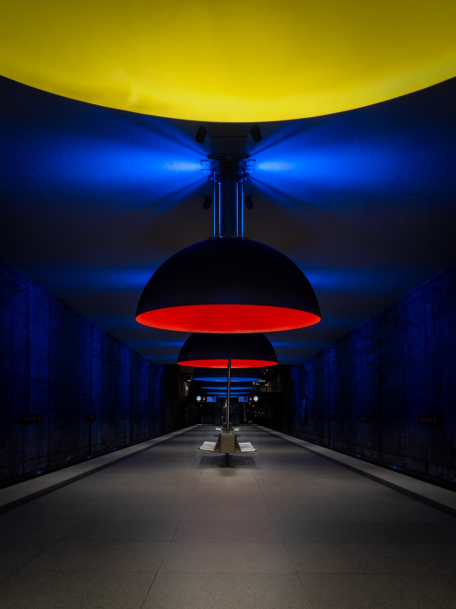 Colourful dome lights illuminate a deserted cavernous station on the U-Bahn in Munich