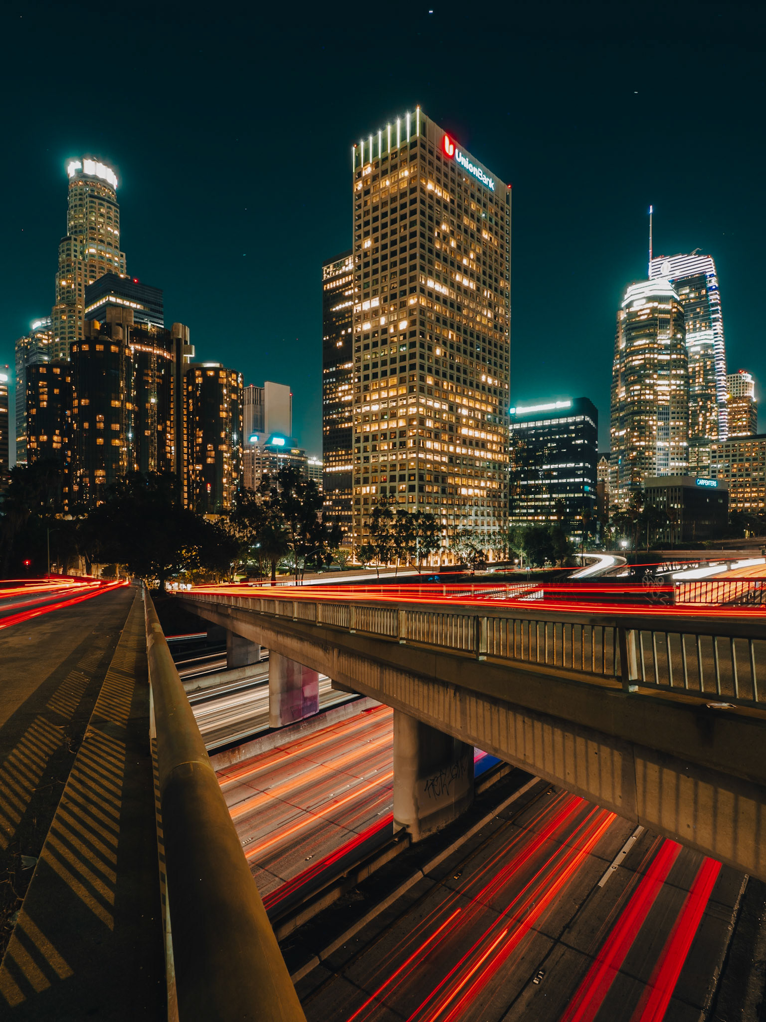 Rush-hour traffic roars past the skyscrapers of downtown Los Angeles