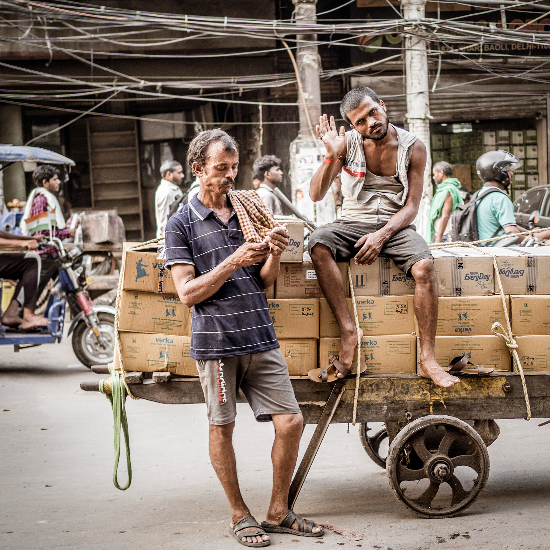 A friendly porter waves hello in the Chandni Chowk district of New Delhi