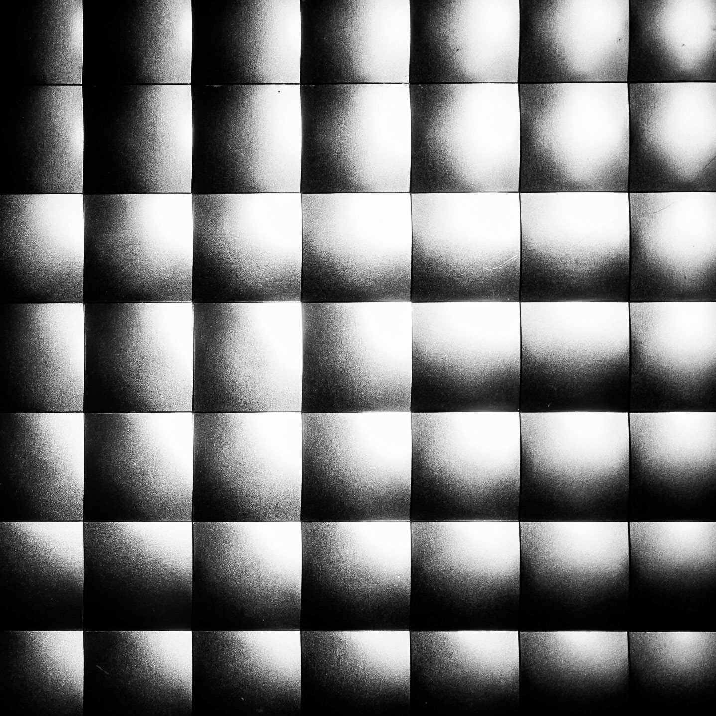 Surreal squares form an abstract grid of shaded blocks