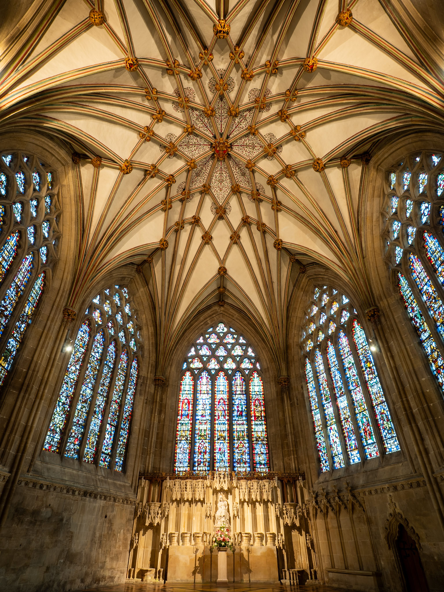 In the Lady Chapel of historic Wells Cathedral, the intricate patterns of the elevated ceiling complement the timeless, narrative colours shining through the ancient stained glass.