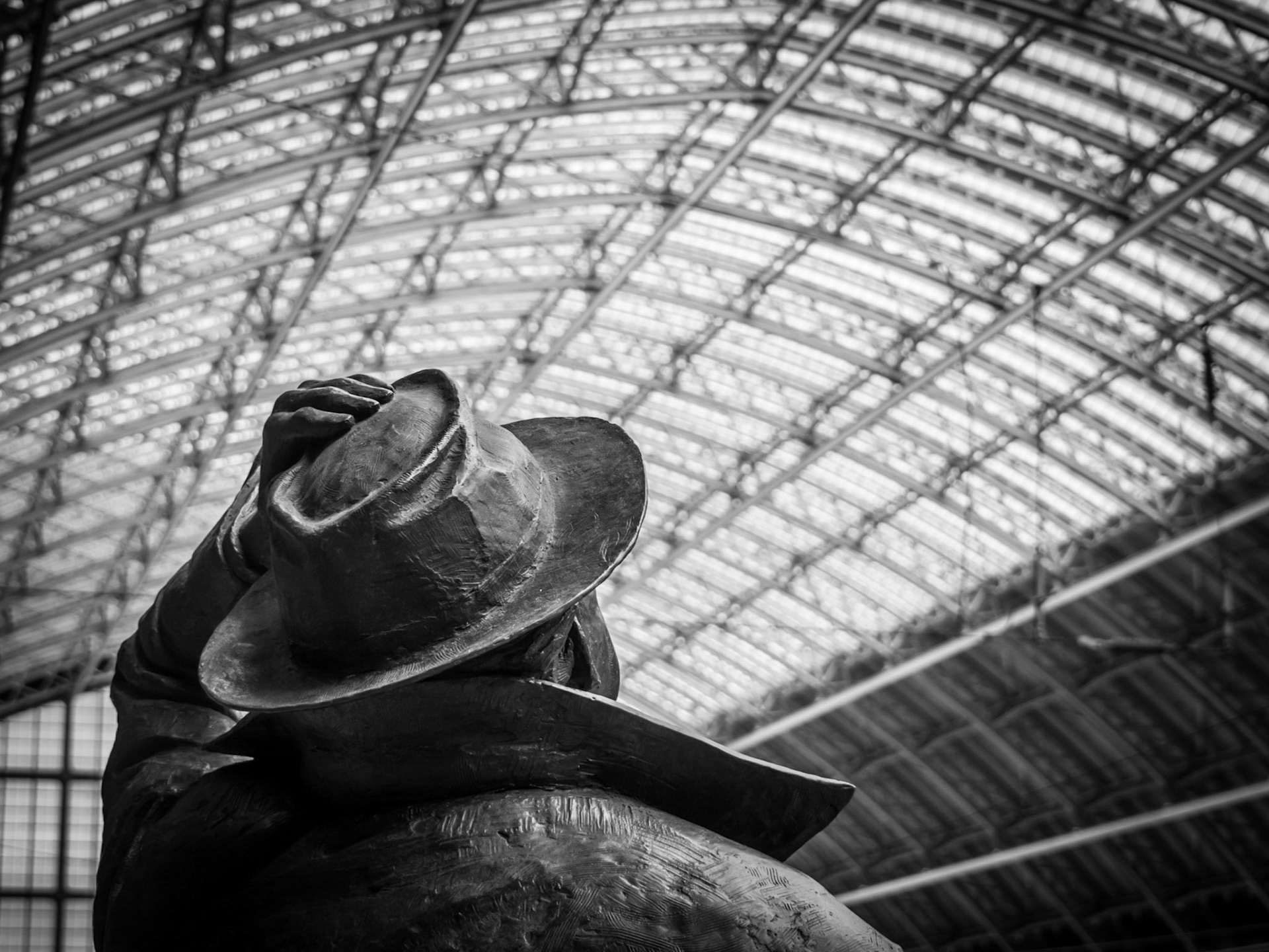 A statue of John Betjemen keeps a paternal eye on travellers passing through Paddington Station, London