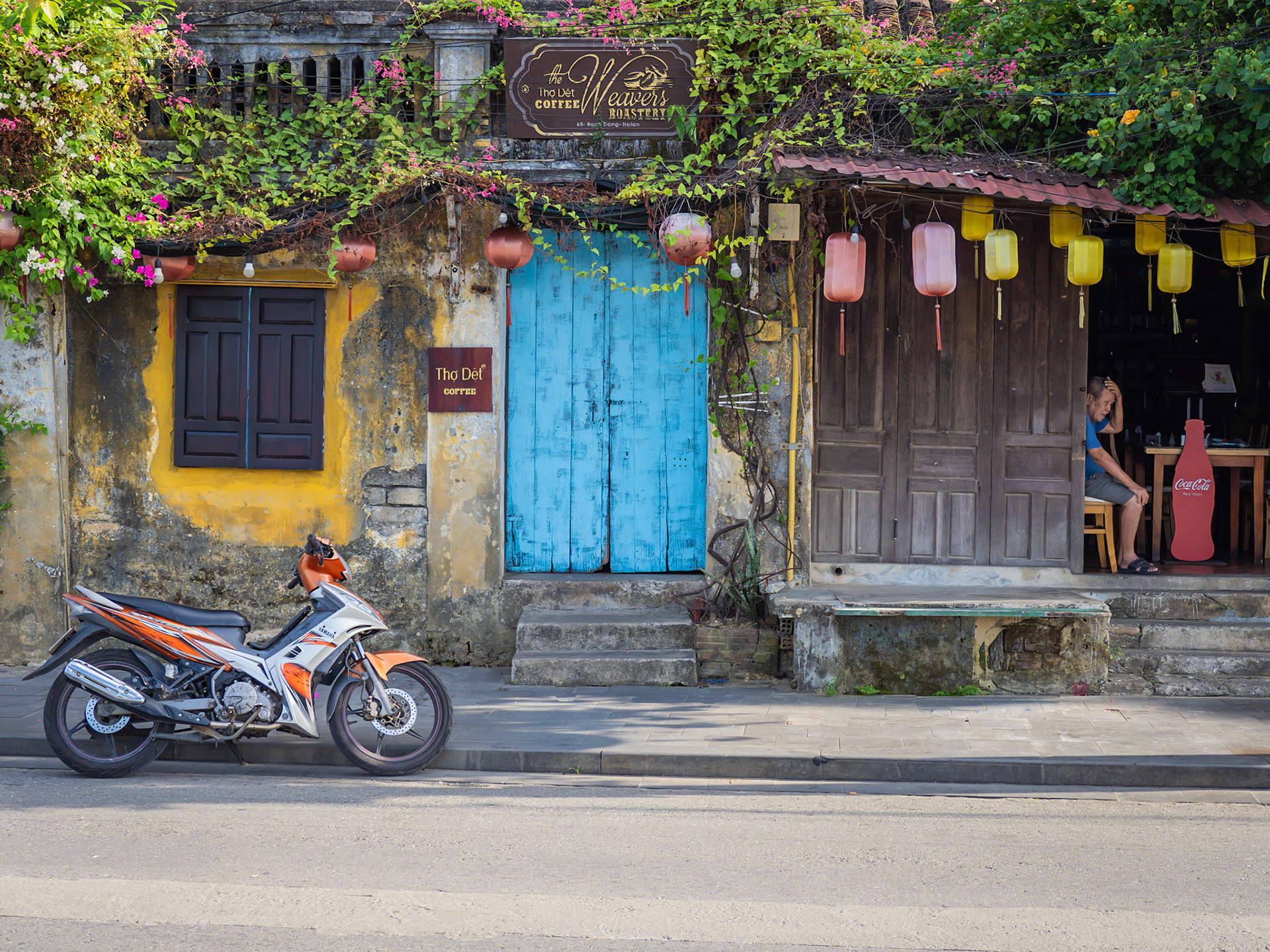 As the ancient Vietnamese city of Hoi An wakes, a pensive cafe owner thinks about the busy day ahead