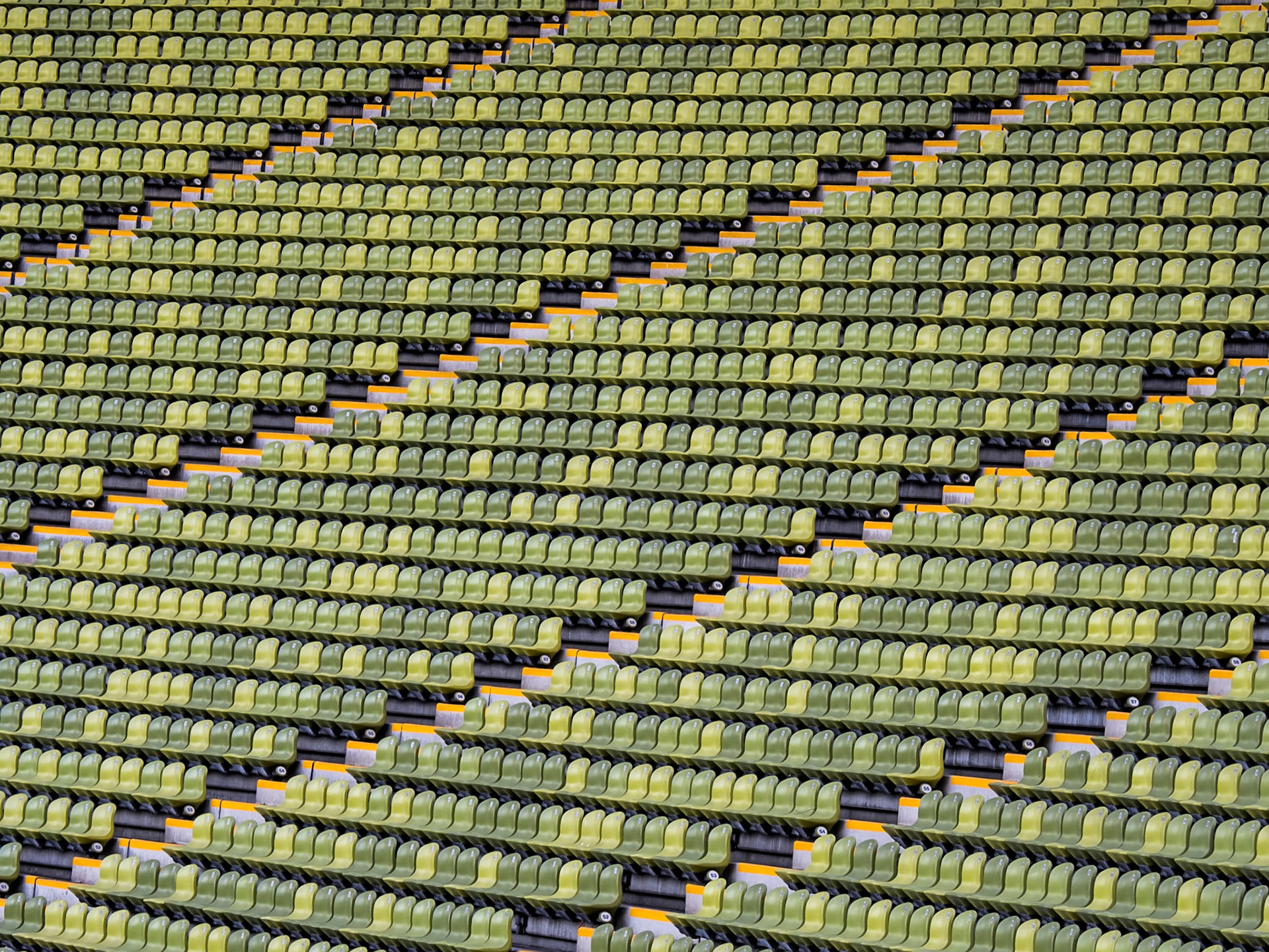 A series of steps carve their way through a bank of green seats in the main Olympic stadium in Munich