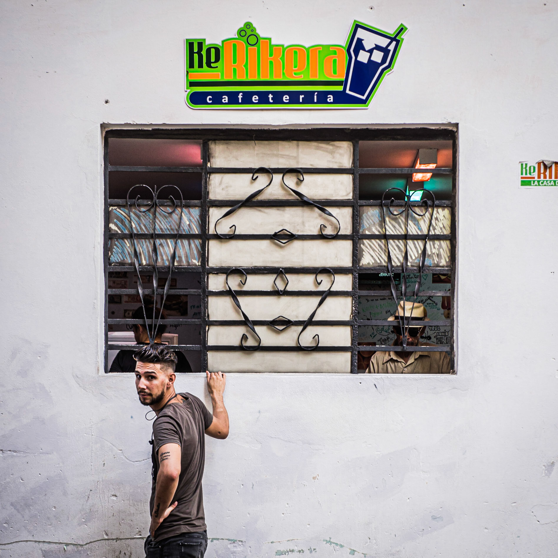 A customer awaits his order at a street-side café on a street in Havana, the capital of Cuba