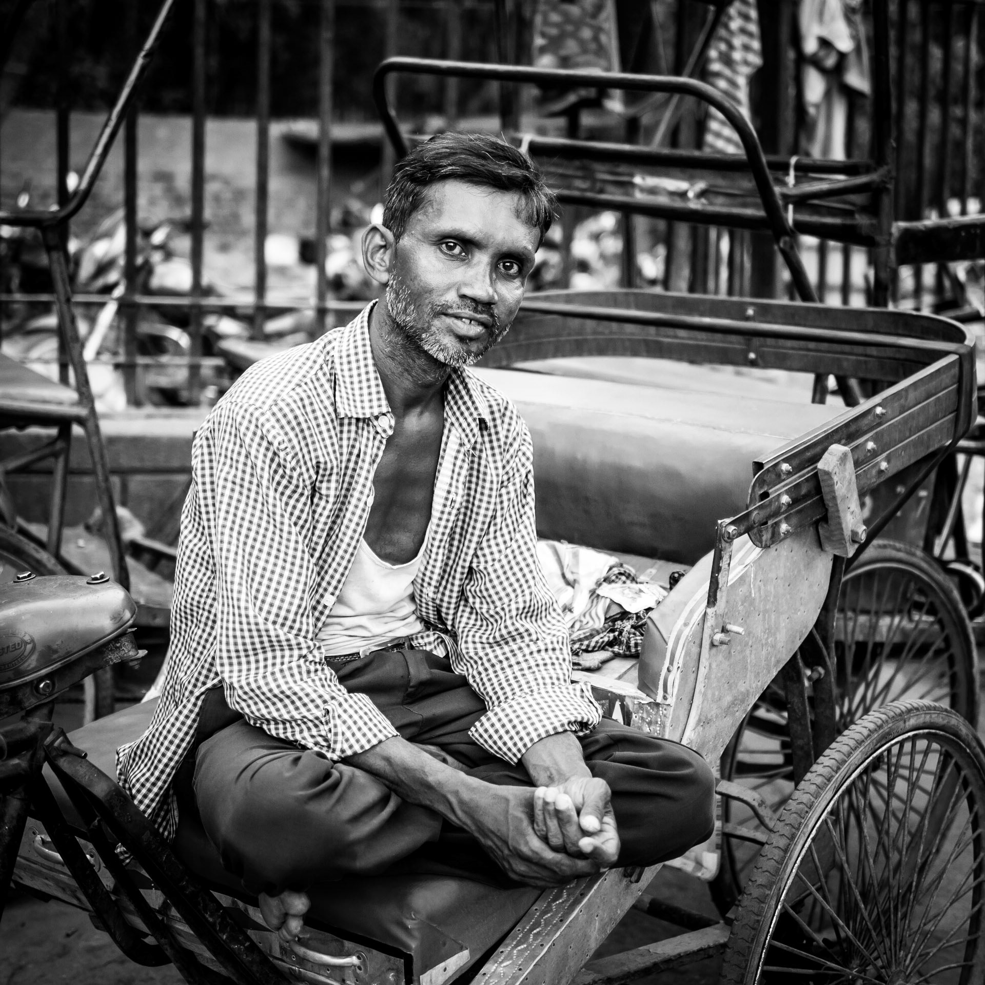 A rickshaw diver appears content in the Chandni Chowk market district of New Delhi