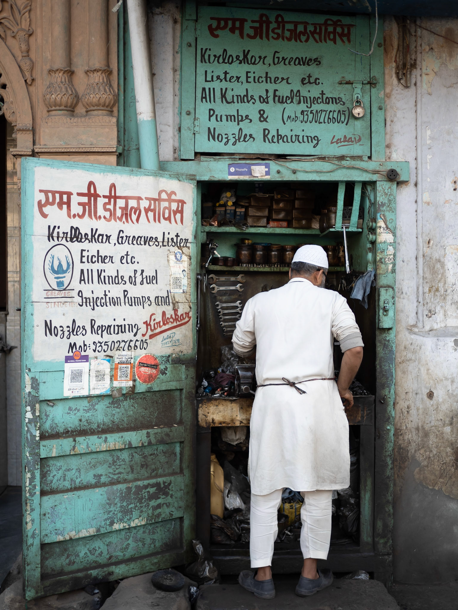 An engineer works in a repair shop in the the Chandni Chowk district of New Delhi