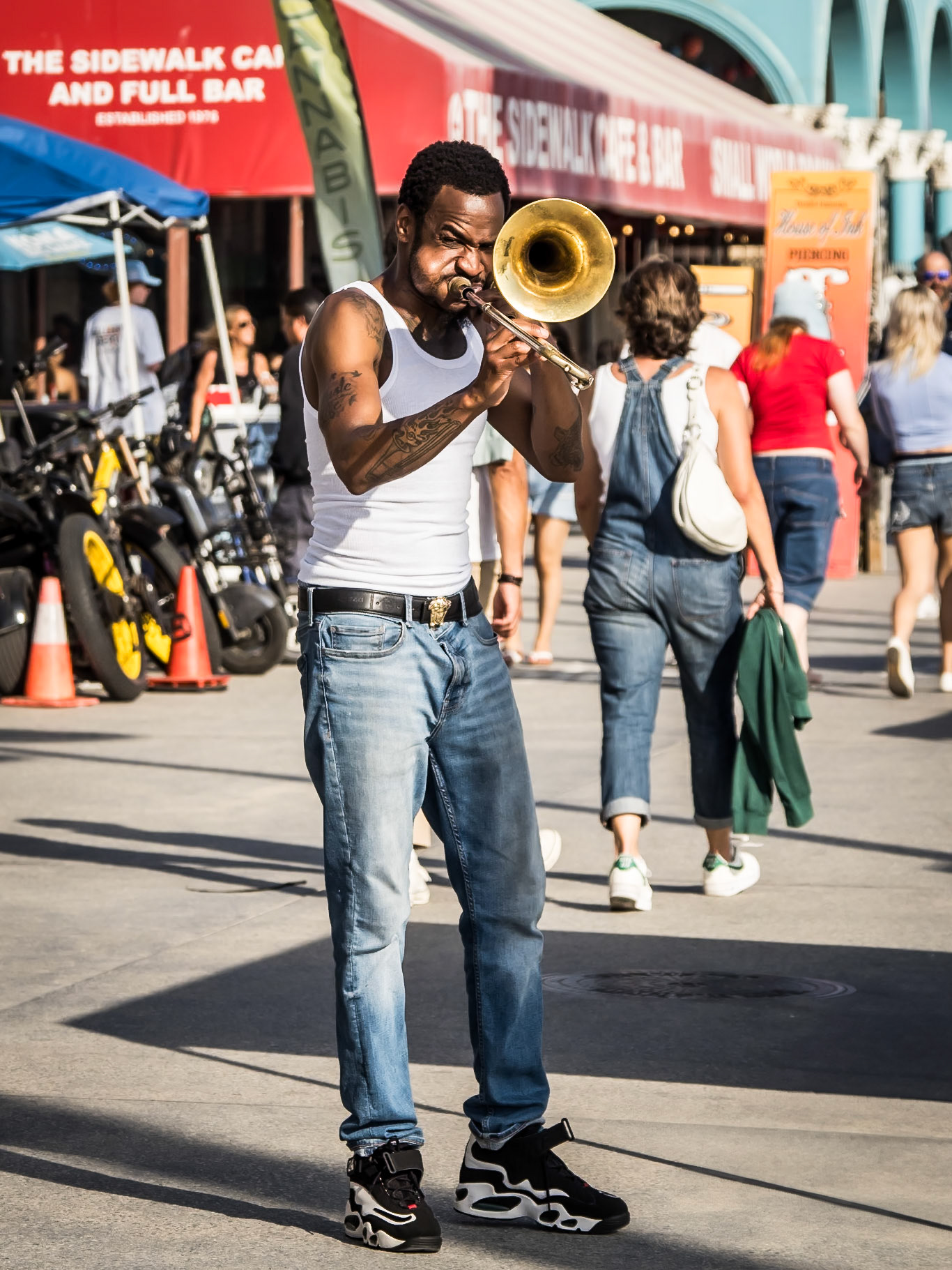 An enthusiastic busker entertains passers-by on the boardwalk of Venice Beach in California