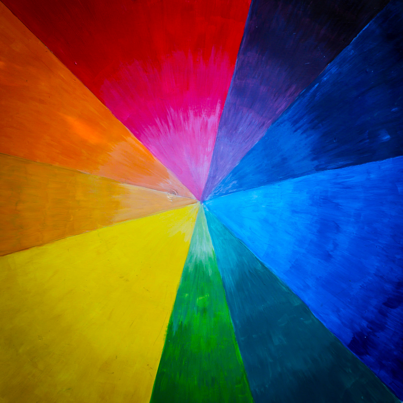 The brush-strokes of a hand-painted wheel of colour