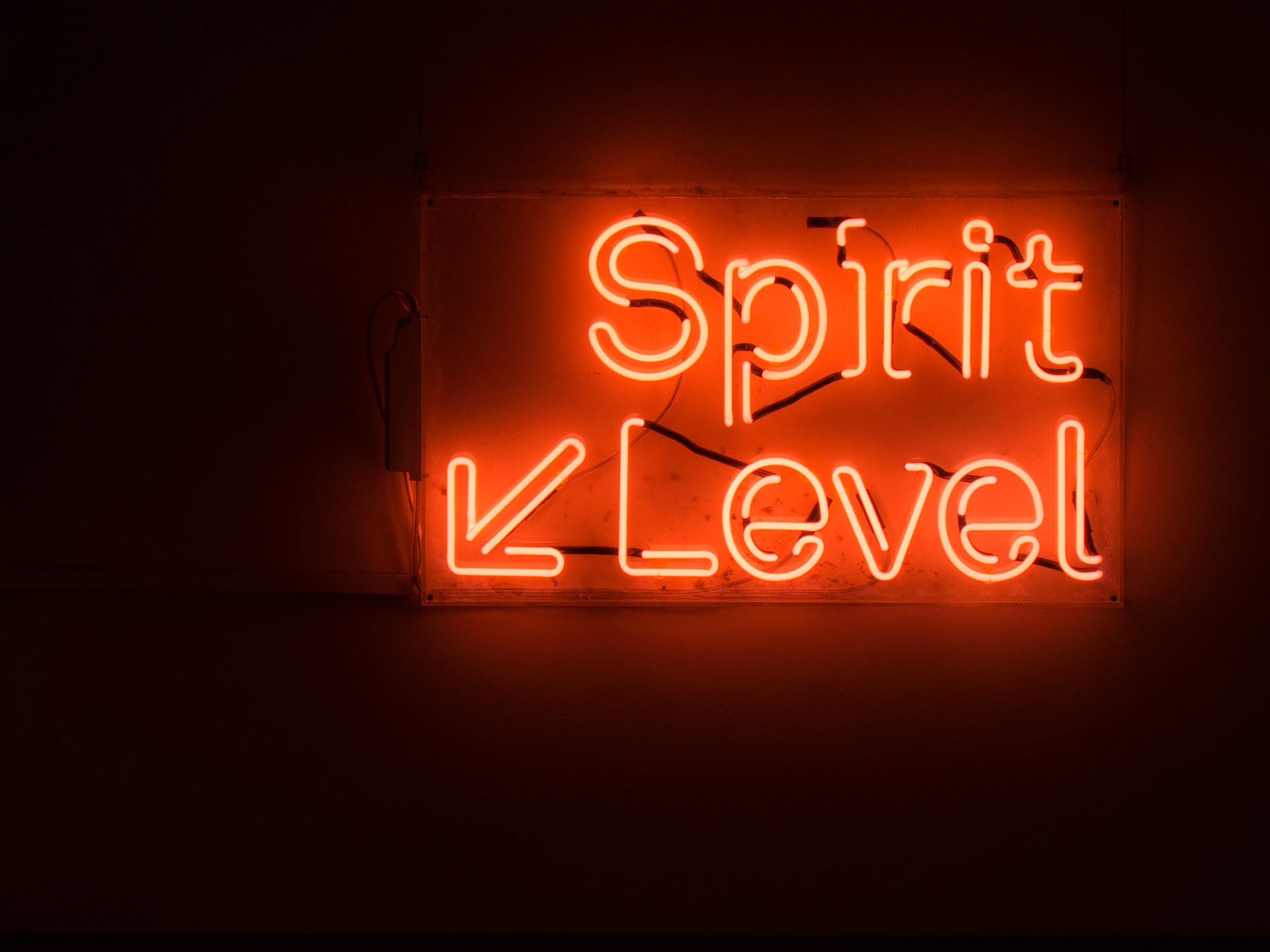 A neon sign welcoming guests to a bar in central London