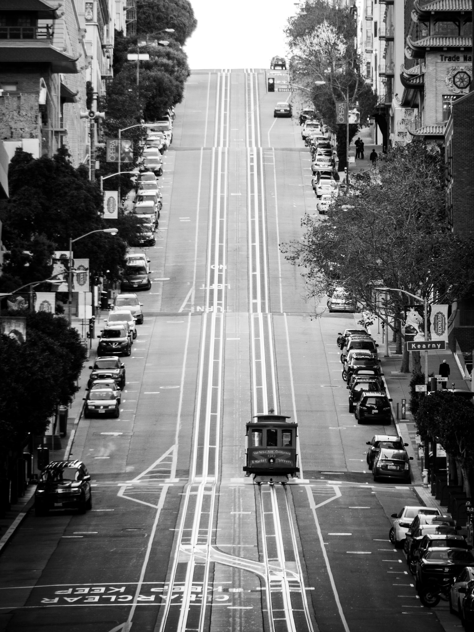 A lone cable-car begins its long climb up California Street in San Francisco