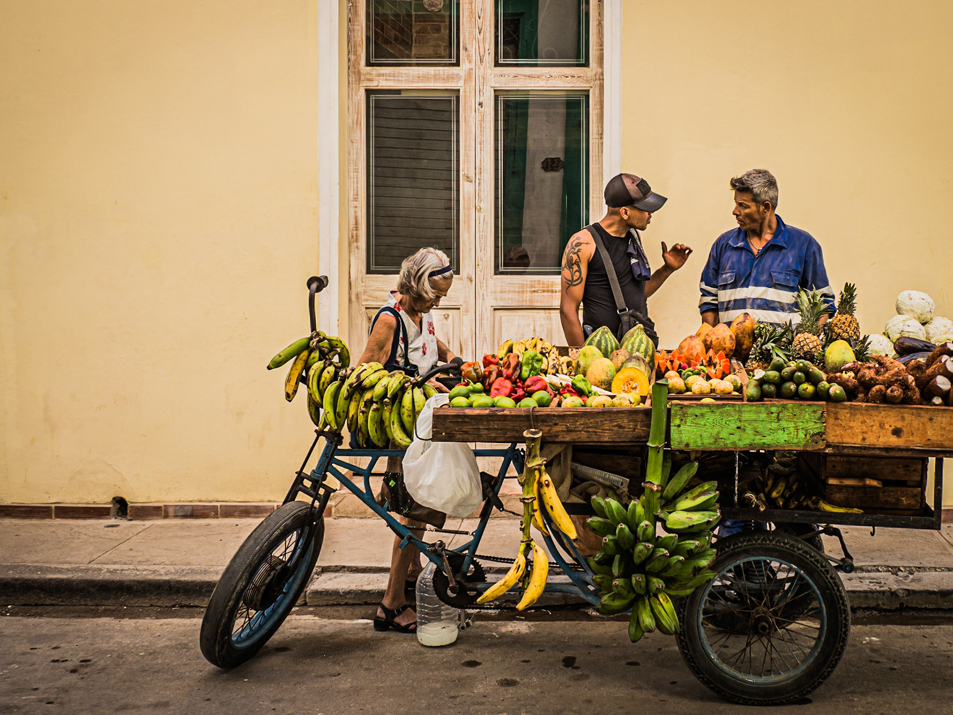 A customer barters to drive down the price of groceries of a street-seller in the streets of Havana, Cuba
