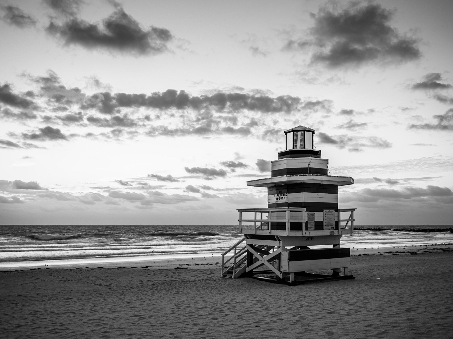 The sun rises behind a life-guard station on South Beach, Miami