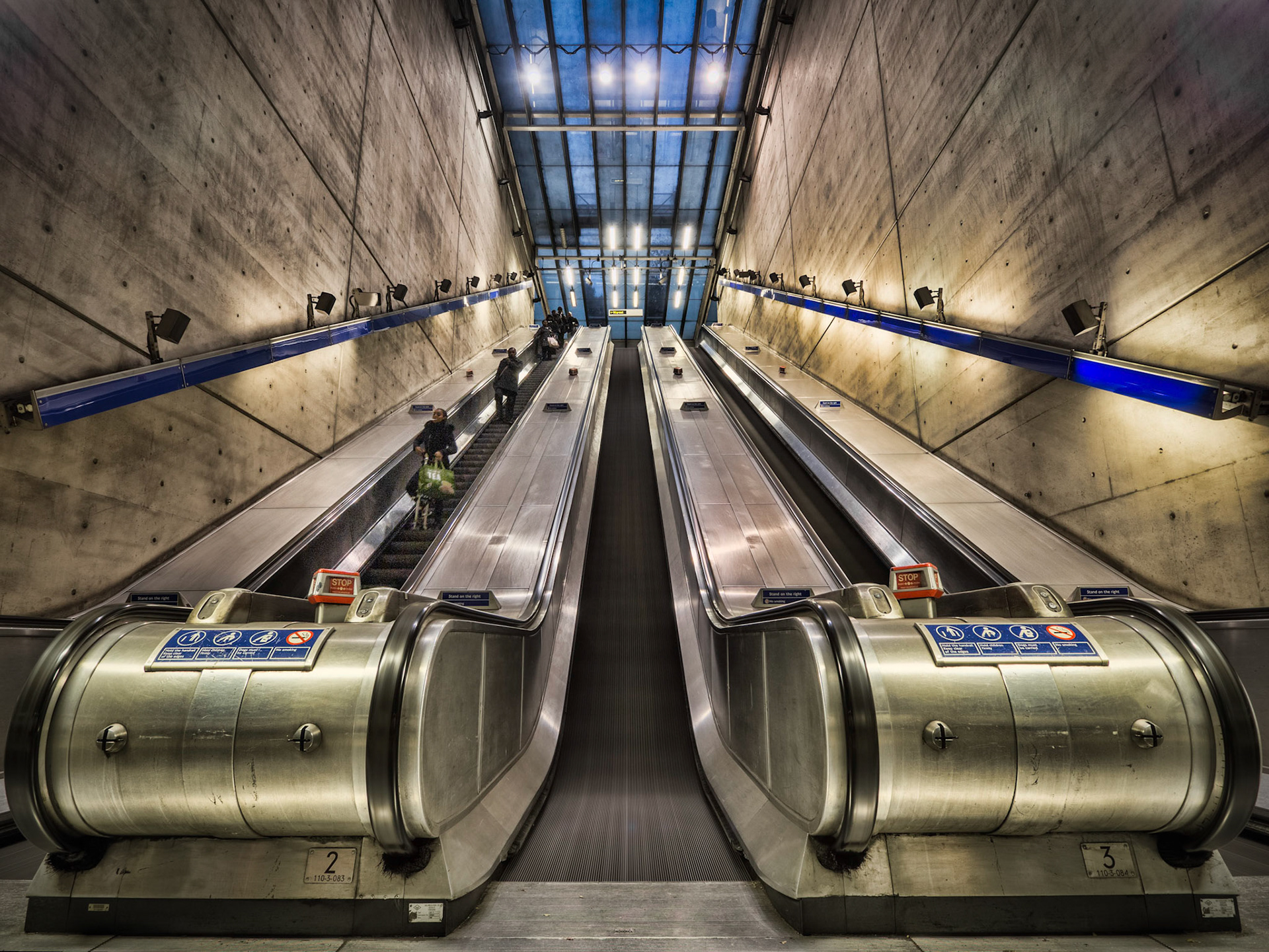 Escalators in the urban Bermondsey tube station carry passengers to and from train platforms