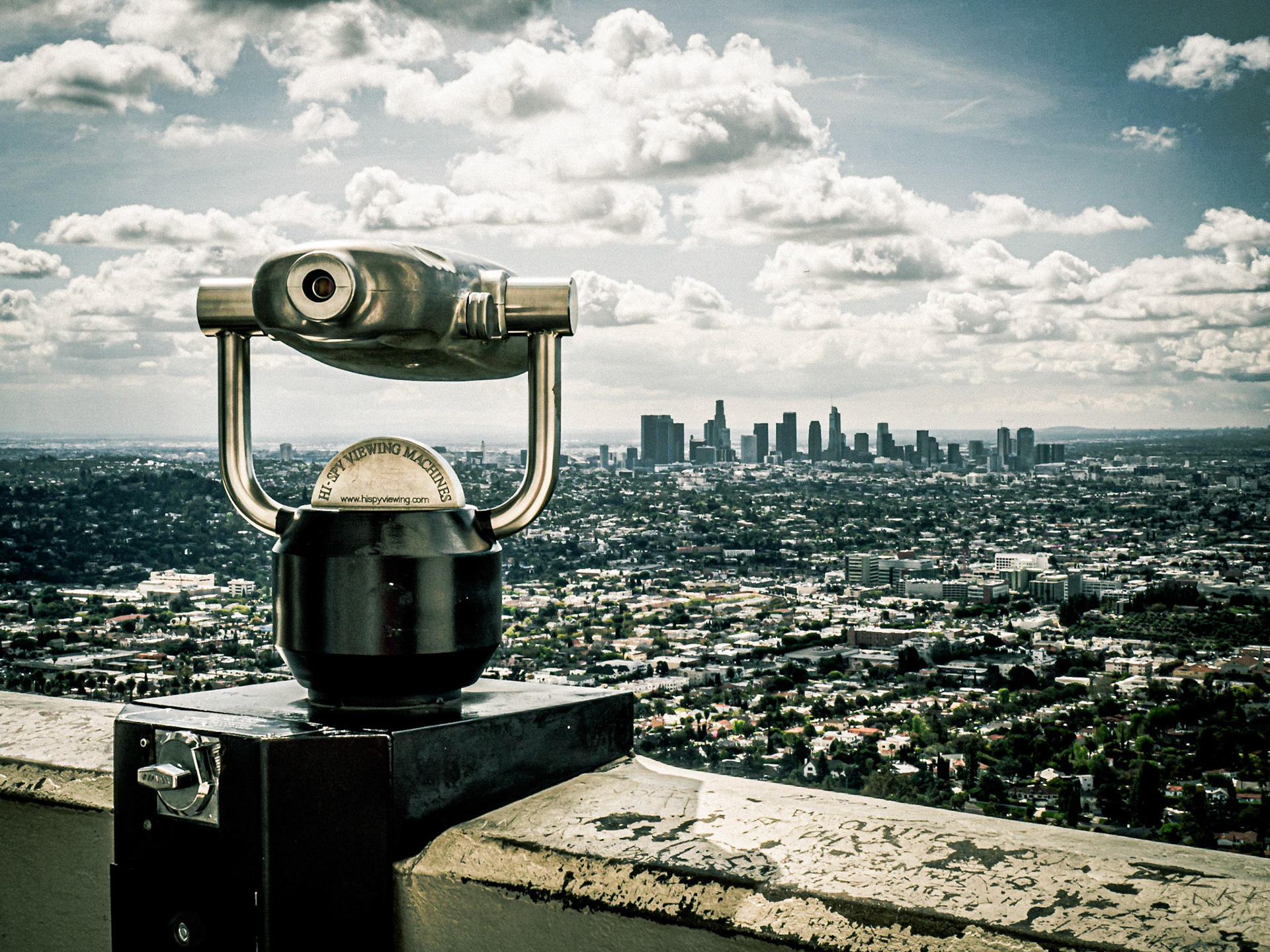 A spy-glass telescope offers viewers to chance to observe downtown Los Angeles from the Griffith Observatory