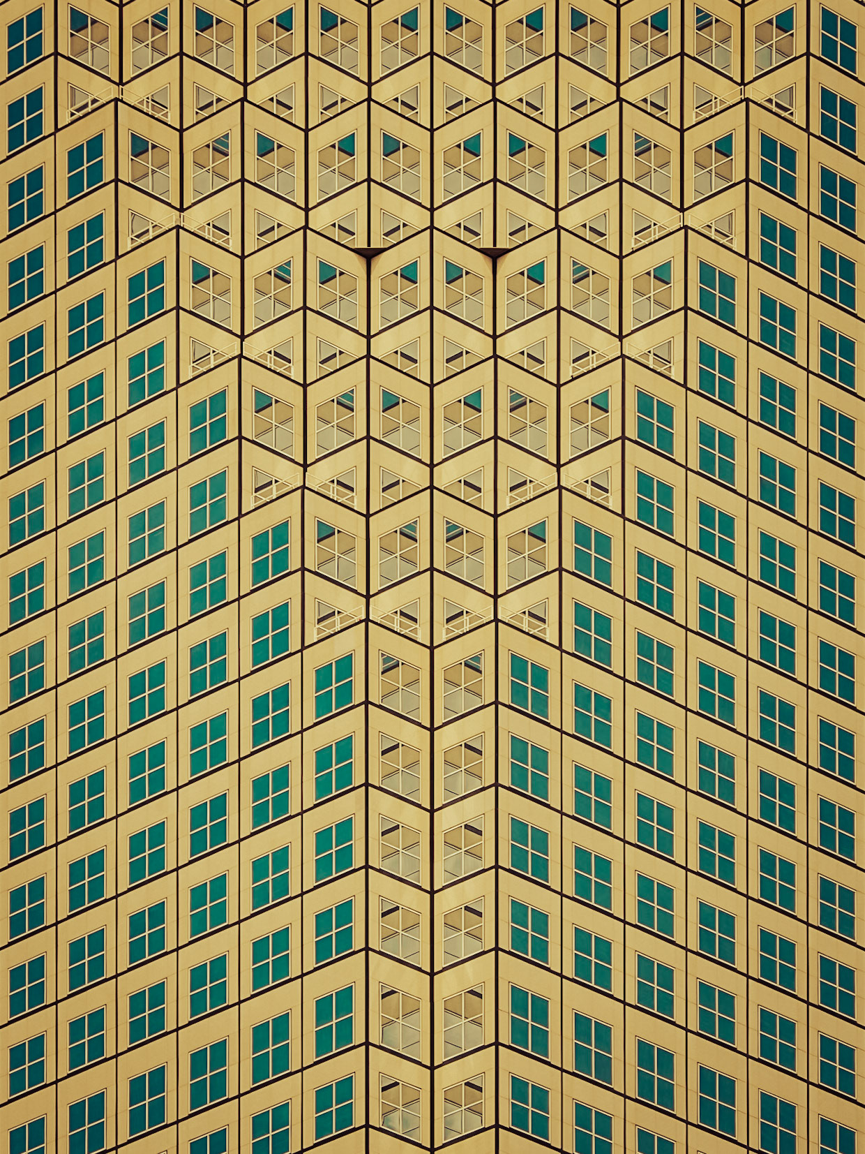 The regular pattern of windows picks out the clear blue pigment of the sky