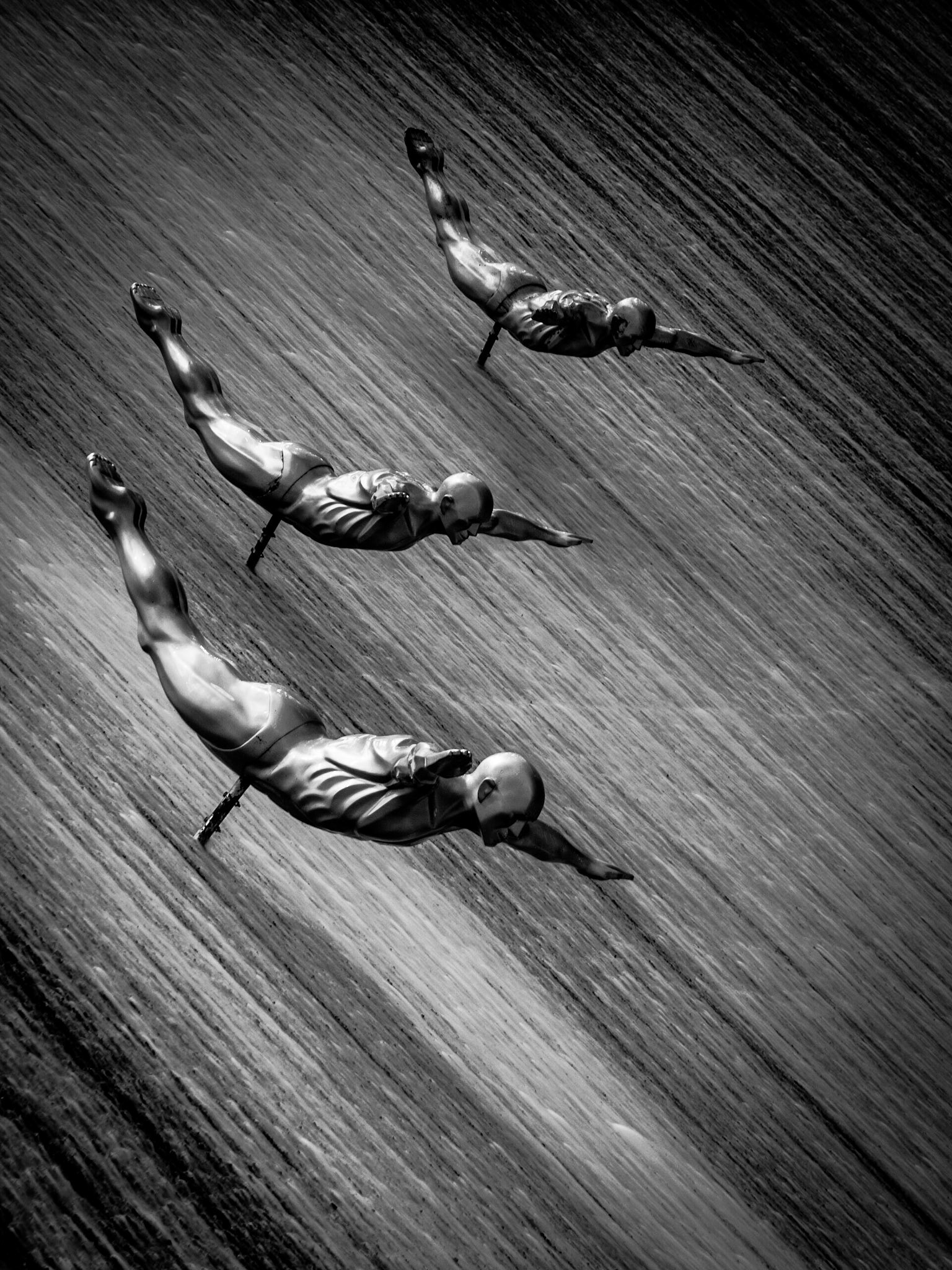 Synchronised divers fly down a waterfall in Dubai