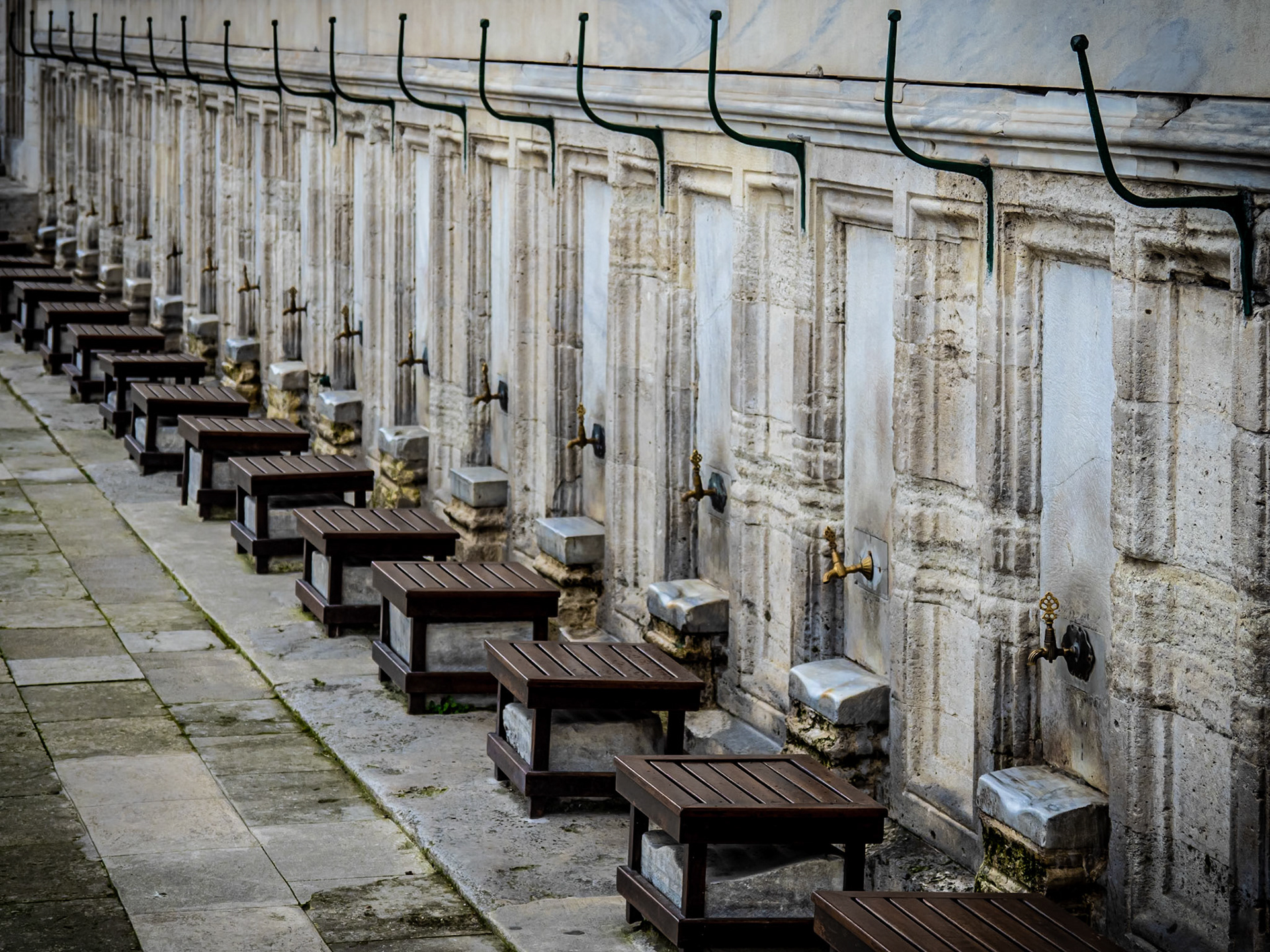 Stools nestle alongside taps in an Istanbul mosque, ready for the ritual washing of feet, hands and arms before prayer