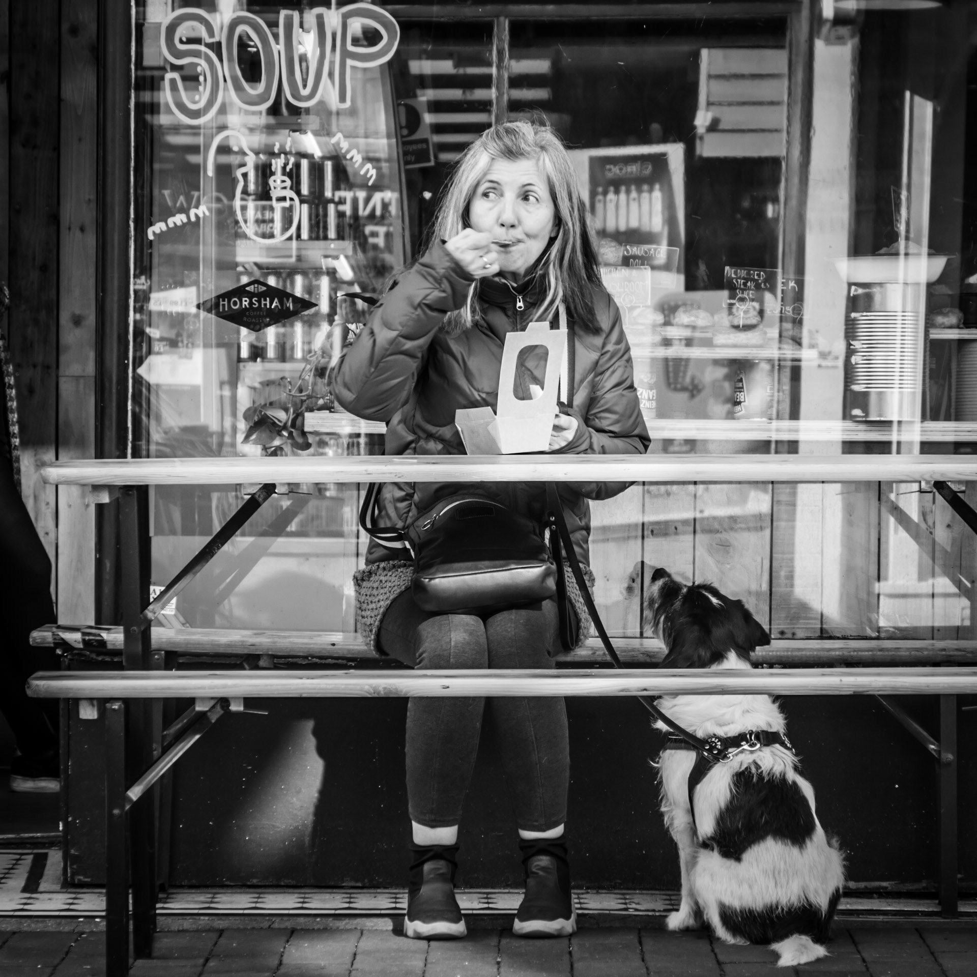A dog looks longingly at its owner hoping for some leftovers in Brighton's North Lanes