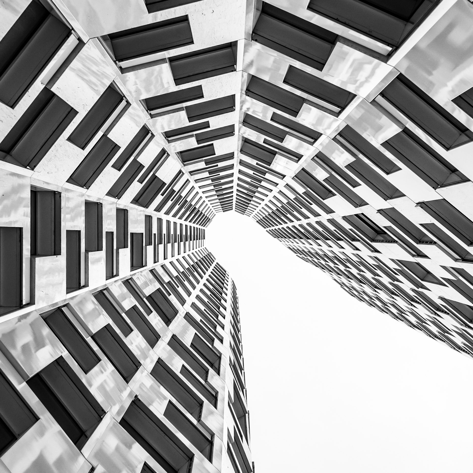 A collection of square windows looking onto the courtyard of a modern hotel in Berlin