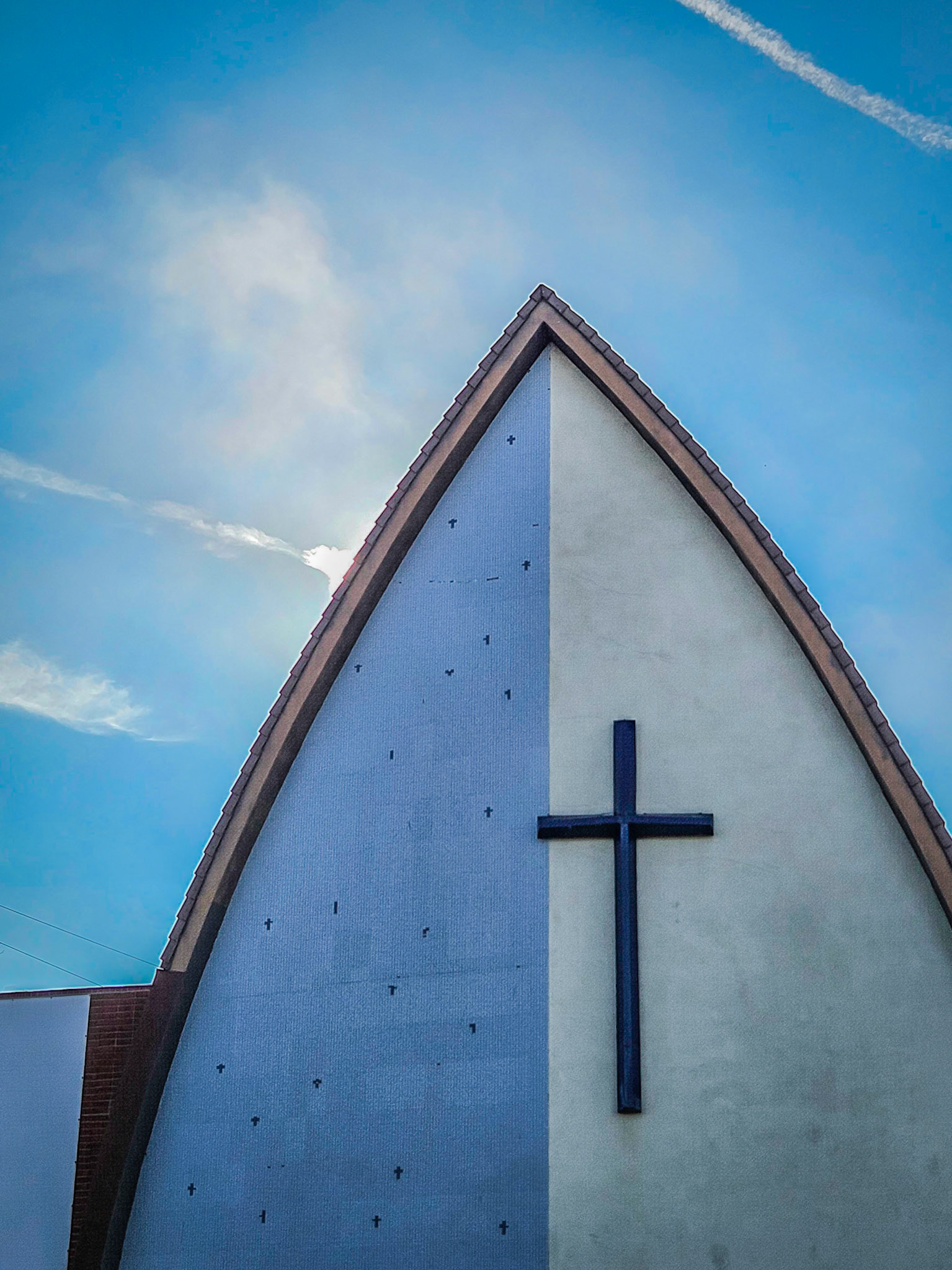 The sun rises behind an unusual church in southern Los Angeles
