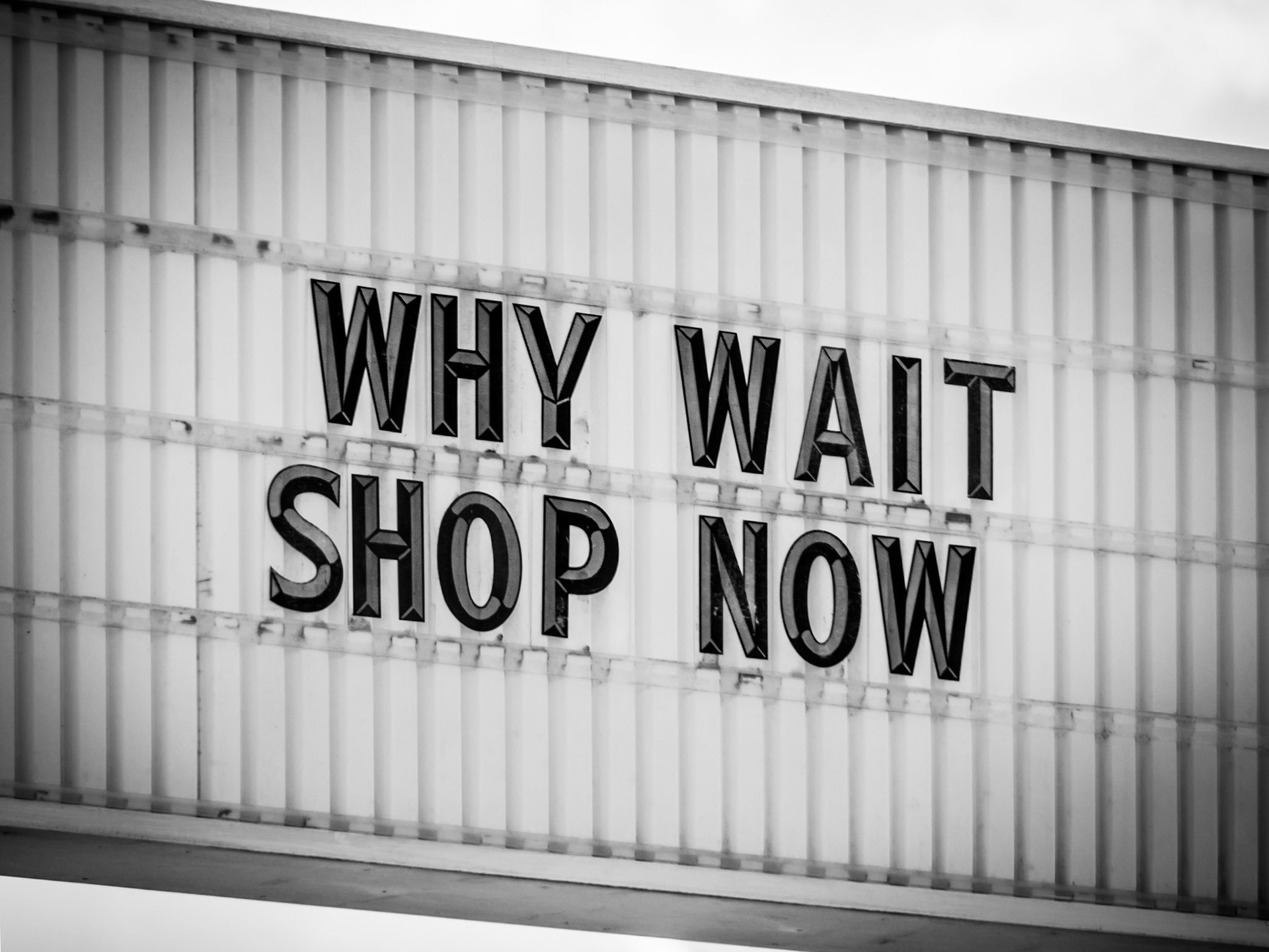 A blatant signs encourages shoppers into a store on a strip-mall in Orlando