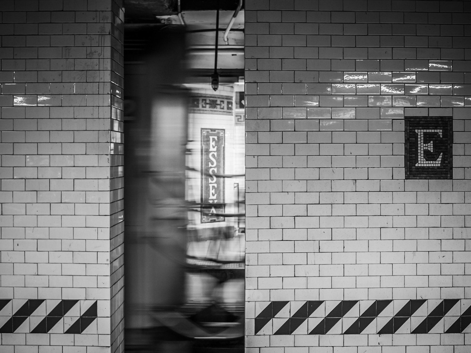 A subway train passes through Essex station in the Lower East Side of Manhattan, New York