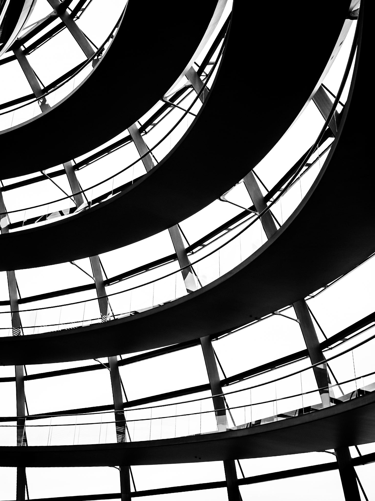 A footpath casts a spiral shadow as it winds its way down and around the huge glass dome of the Reichstag parliamentary building in Berlin