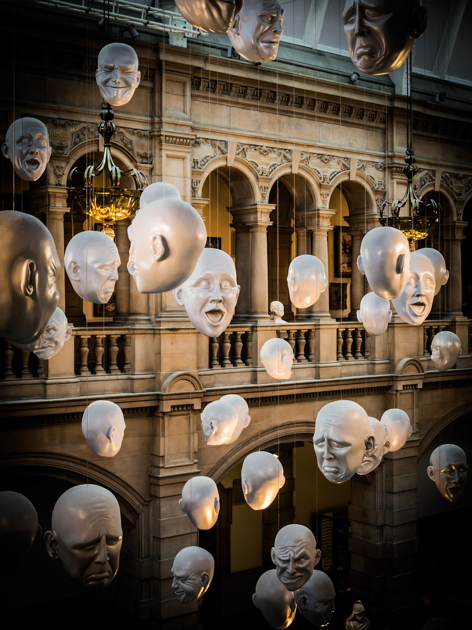 A contemporary art installation of hanging heads located in the Kelvingrove Museum in Glasgow