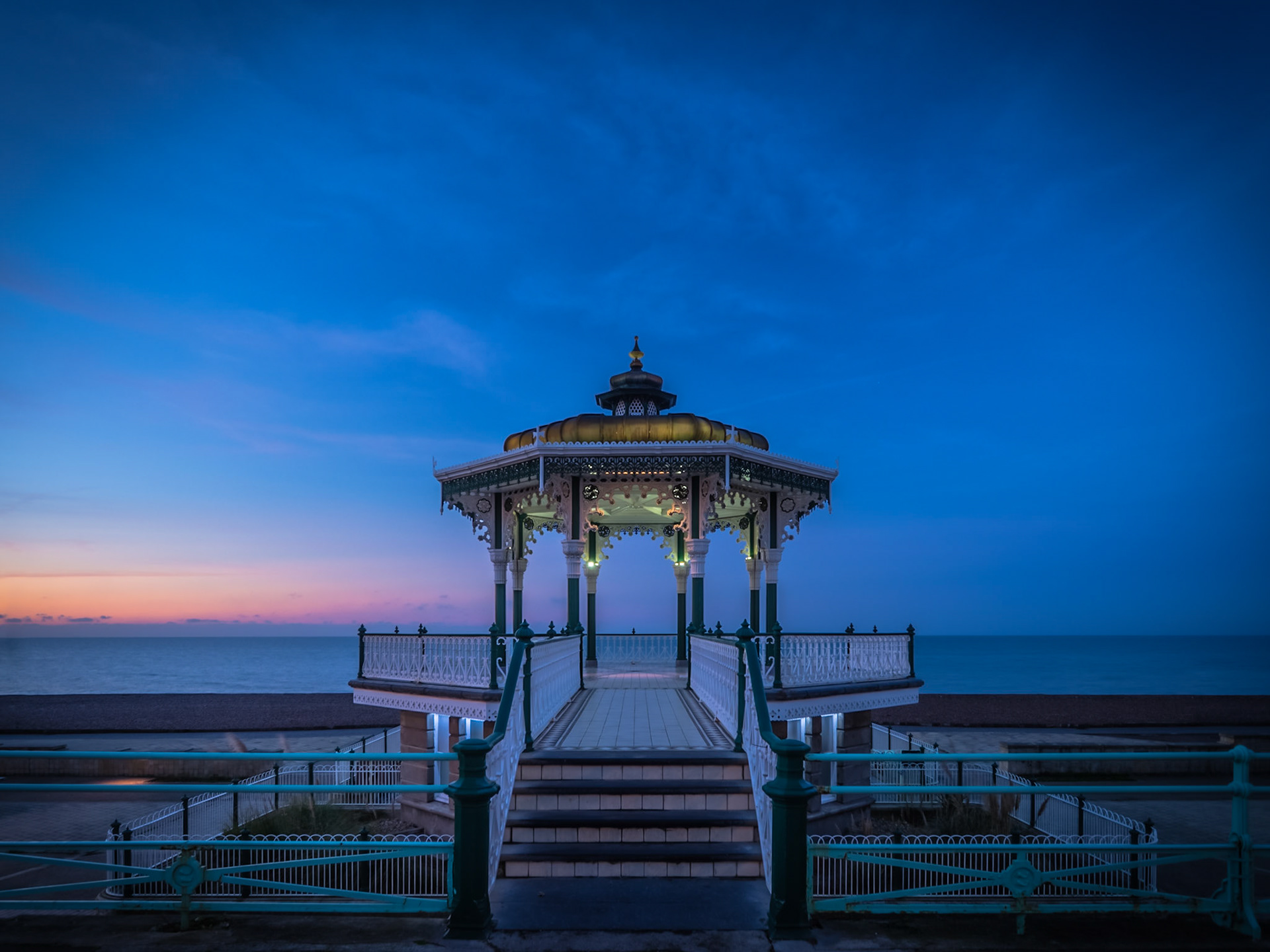 A spectacular dawn rises behind the bandstand on Brighton seafront