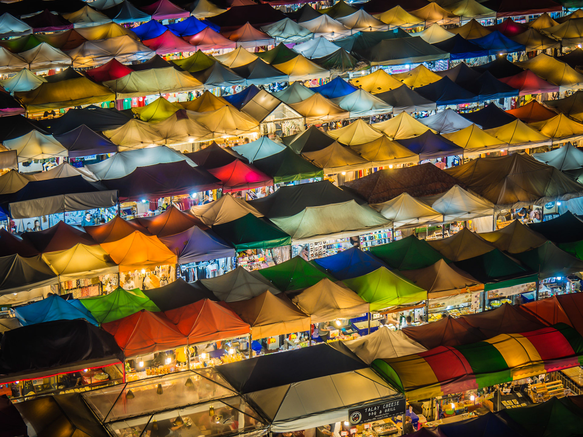 Colourful awnings glow at the Ratchada night market in Bangkok