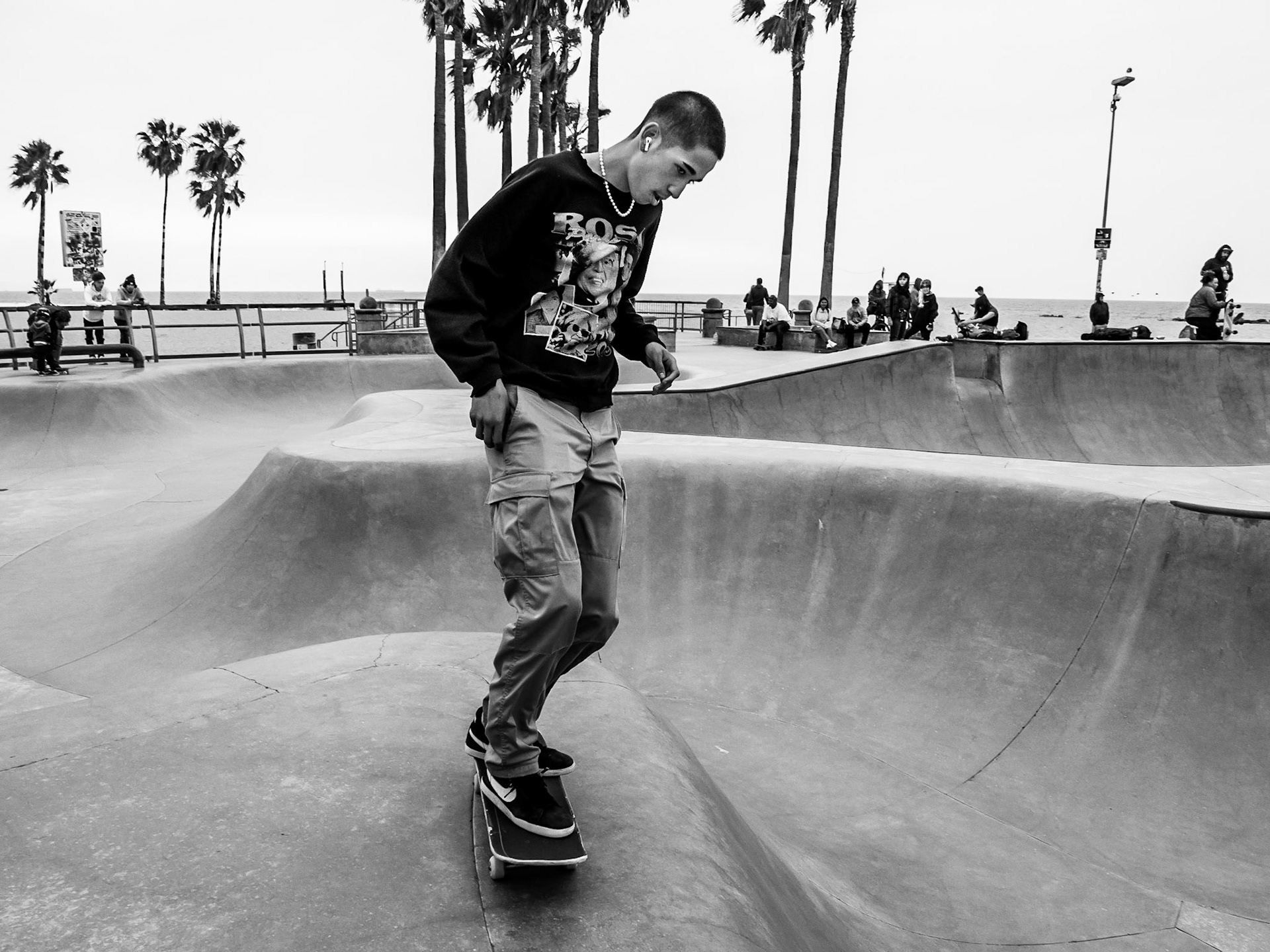 A young skateboarder prepares for another run though the bowls of the skatepark on Venice Beach in Los Angeles