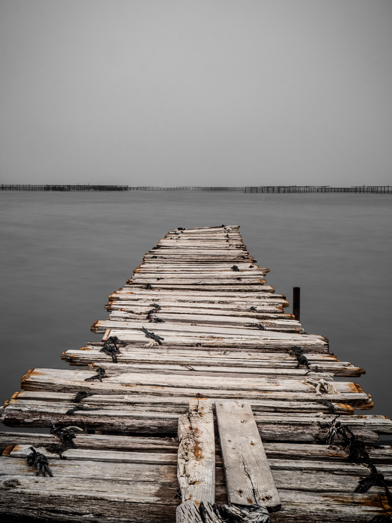 A rustic jetty stretches out into the water near Méze, southern France