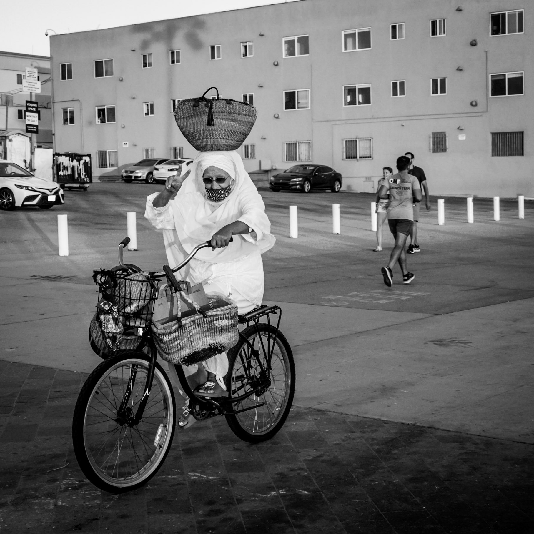 A local gestures a friendly sign on a very quiet Venice Beach in the depth of the COVID-19 pandemic