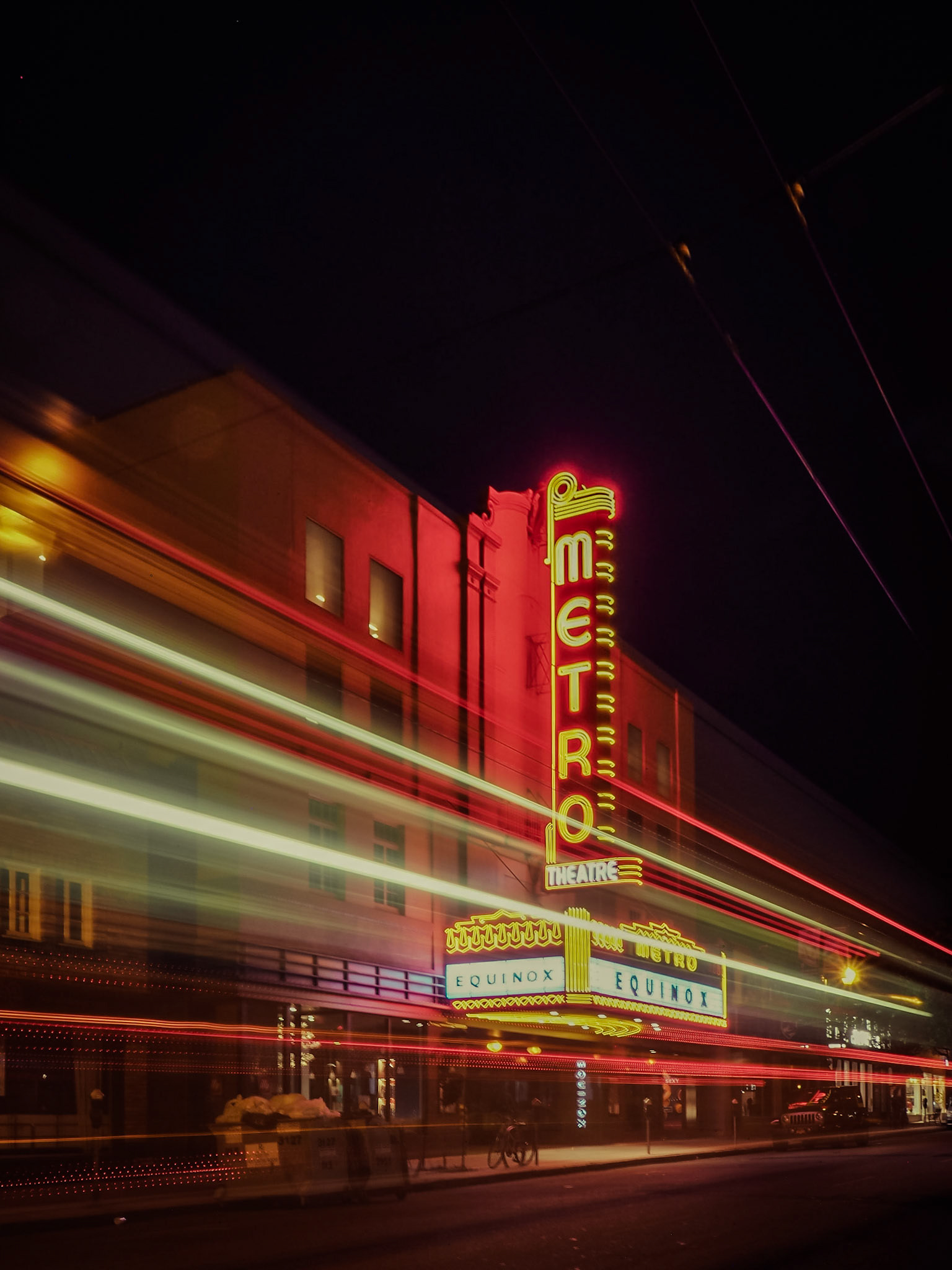 Passing traffic forms trails of light in front of the Metro Theatre in the Russian Hill district of San Francisco