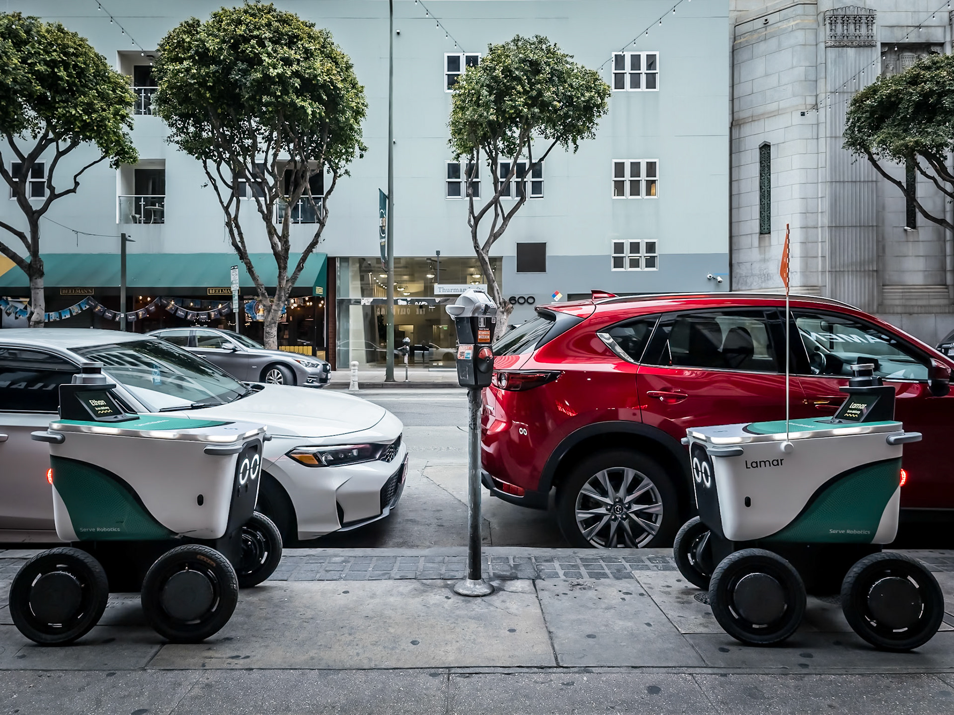 Two delivery robots stare at eachother during a face-off in downtown Los Angeles