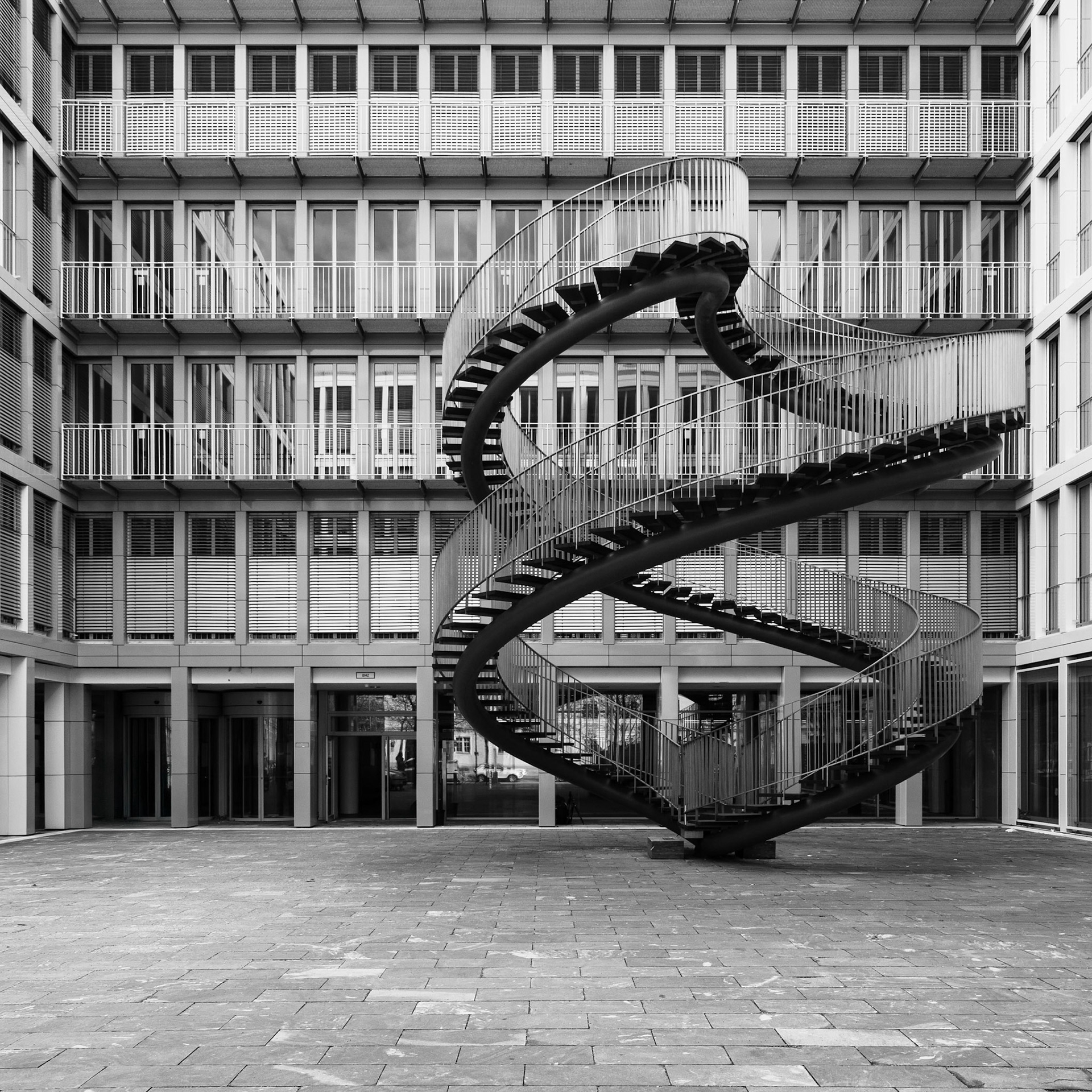 The curves of a spiralling endless staircase contrast with the rigid, rectangular architectural design an office block in Munich