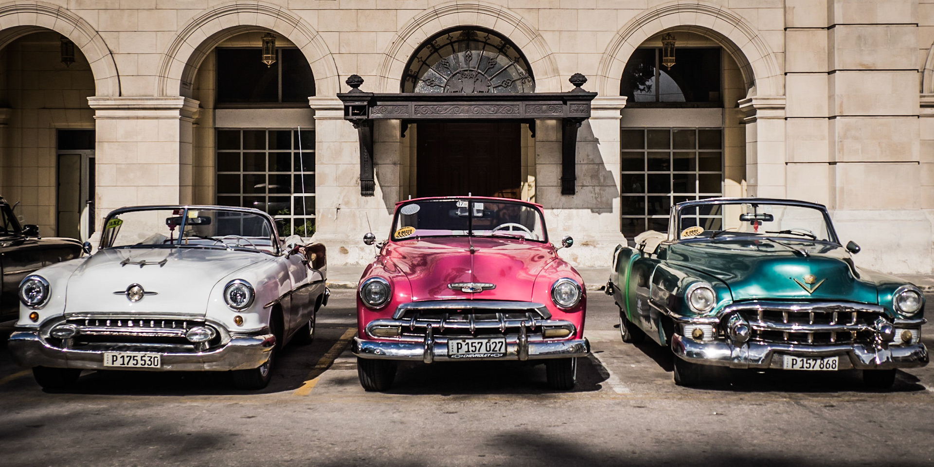 Classic cars gleam in the sun as their owners await their next passengers - many are now restored and operate as taxis around the Cuban capital, Havana