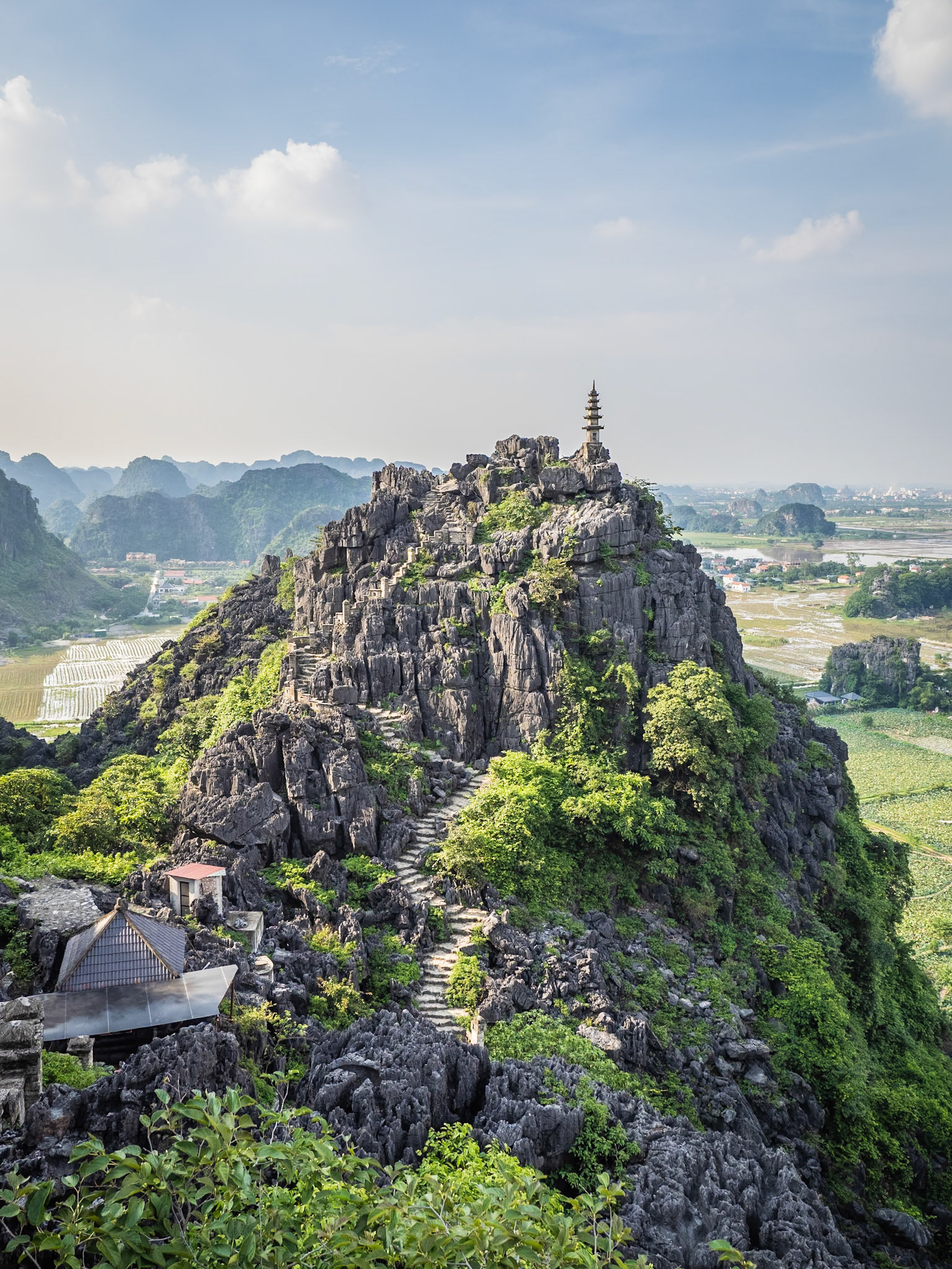 Hundreds of steps lead to a small pagoda that sits at the peak of Lying Dragon Mountain in Ninh Binh, Vietnam