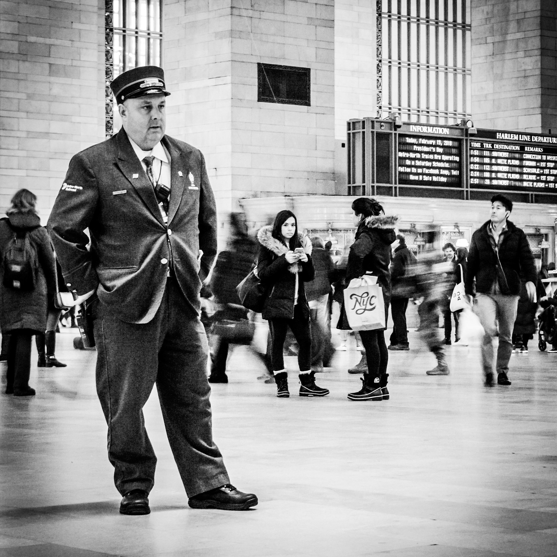 A guard watches patiently as commuters pass through the concourse of Grand Central Terminal in Manhattan, New York