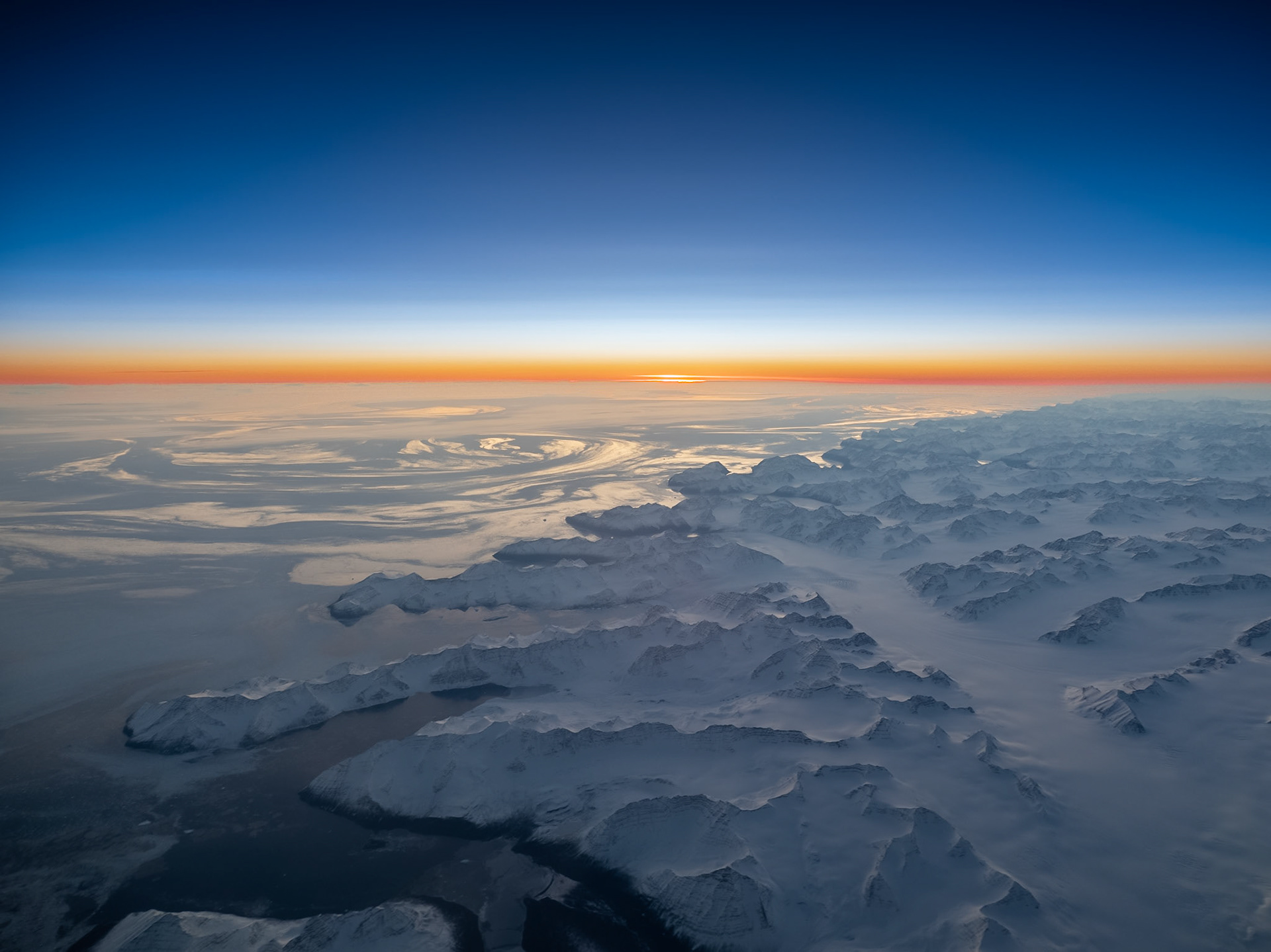 Stunning, circular ice flows form as the sun sets off the frozen coast of Greenland
