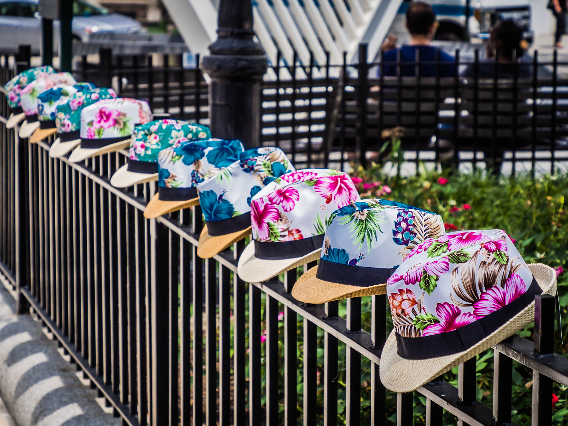 Colourful panama hats lined up for sale along a fence in the Greenwhich Village district of Manhattan, New York